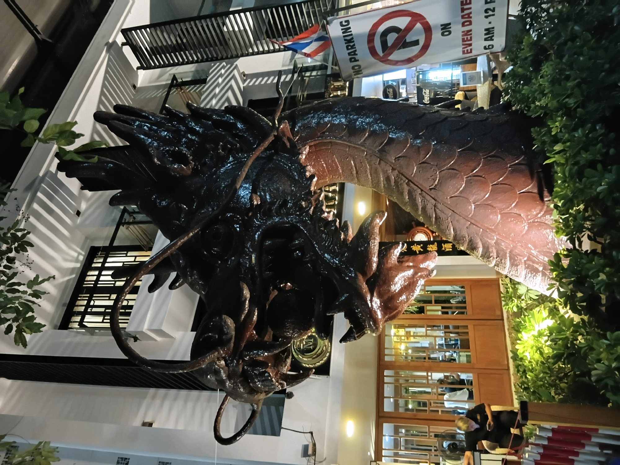 Chiang Mai night scene: dragon statue, covered market, tuk-tuk