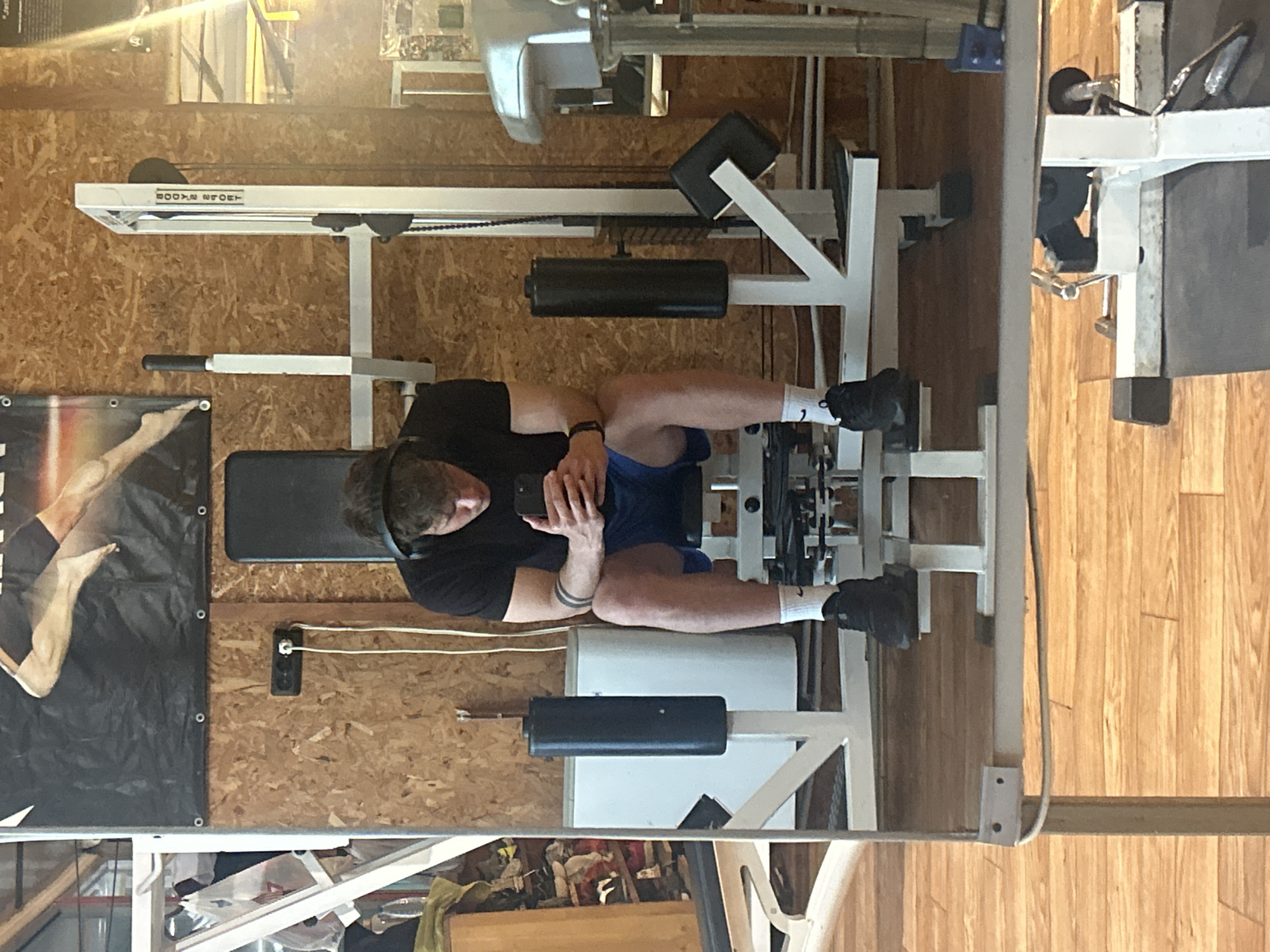 Man uses phone while exercising at Bulgarian gym