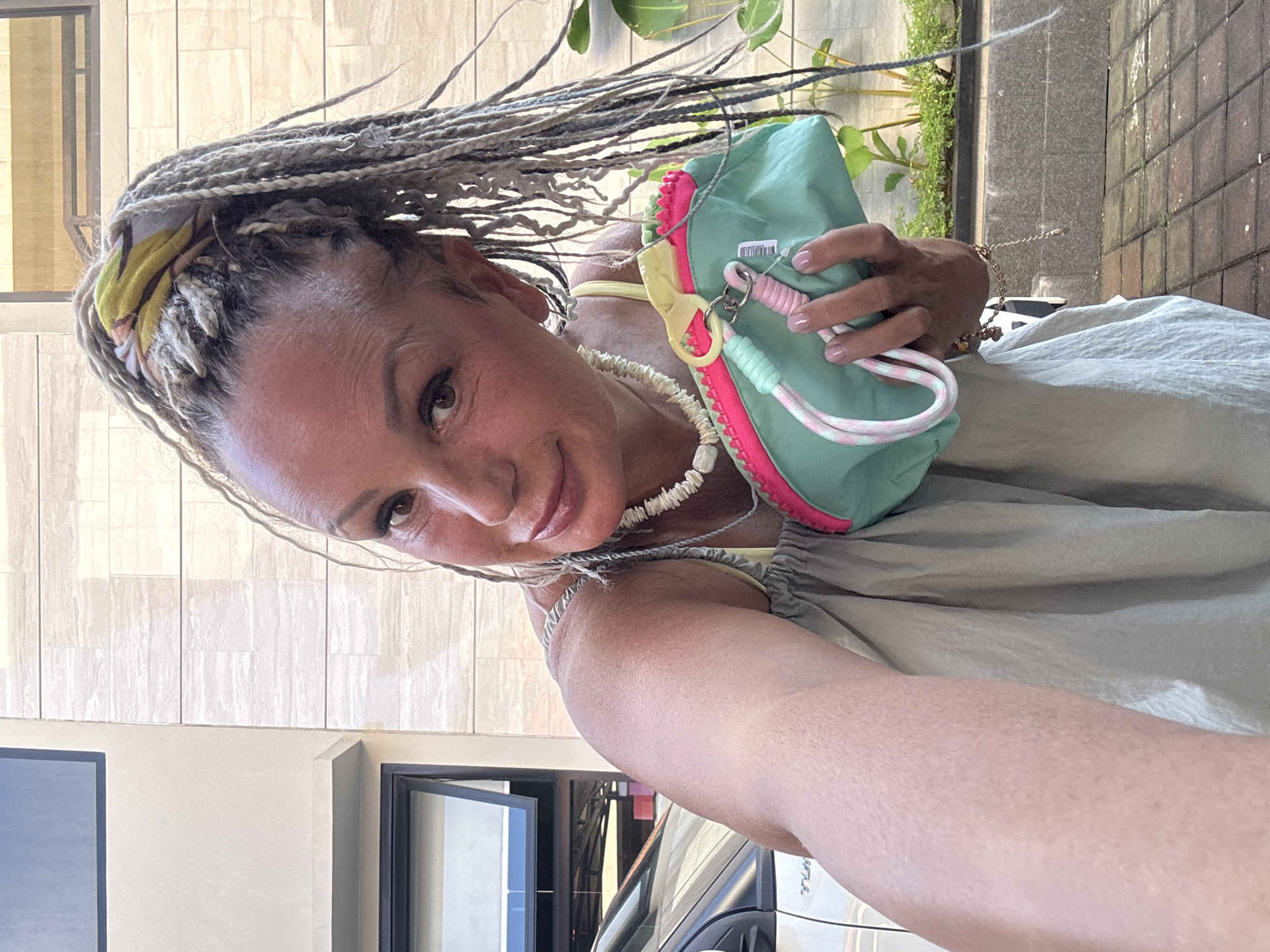 Woman takes selfie with colorful accessories in Kuta