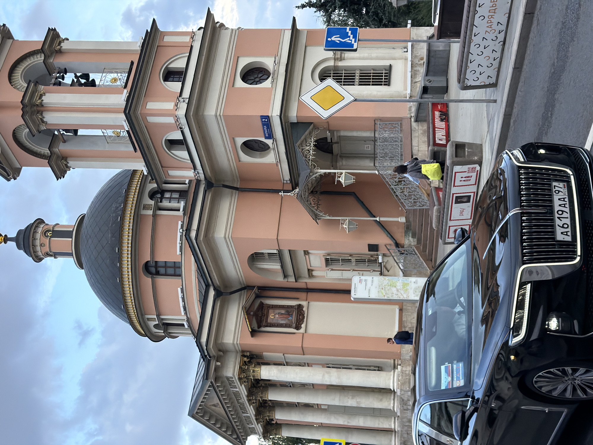 Russian-plated sedan parked near a pink domed church