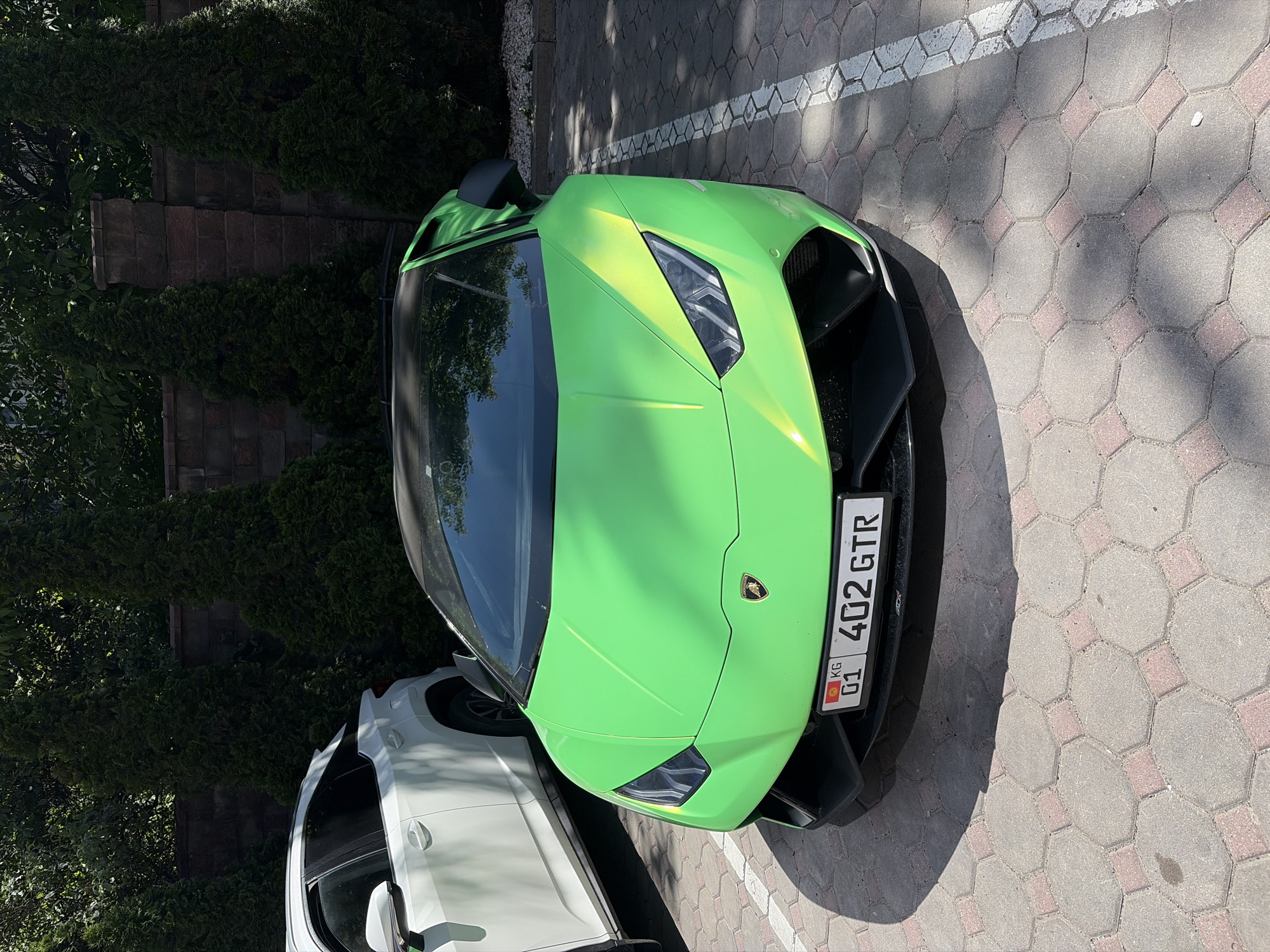 Green Lamborghini spotted parked in Almaty cobblestone lot