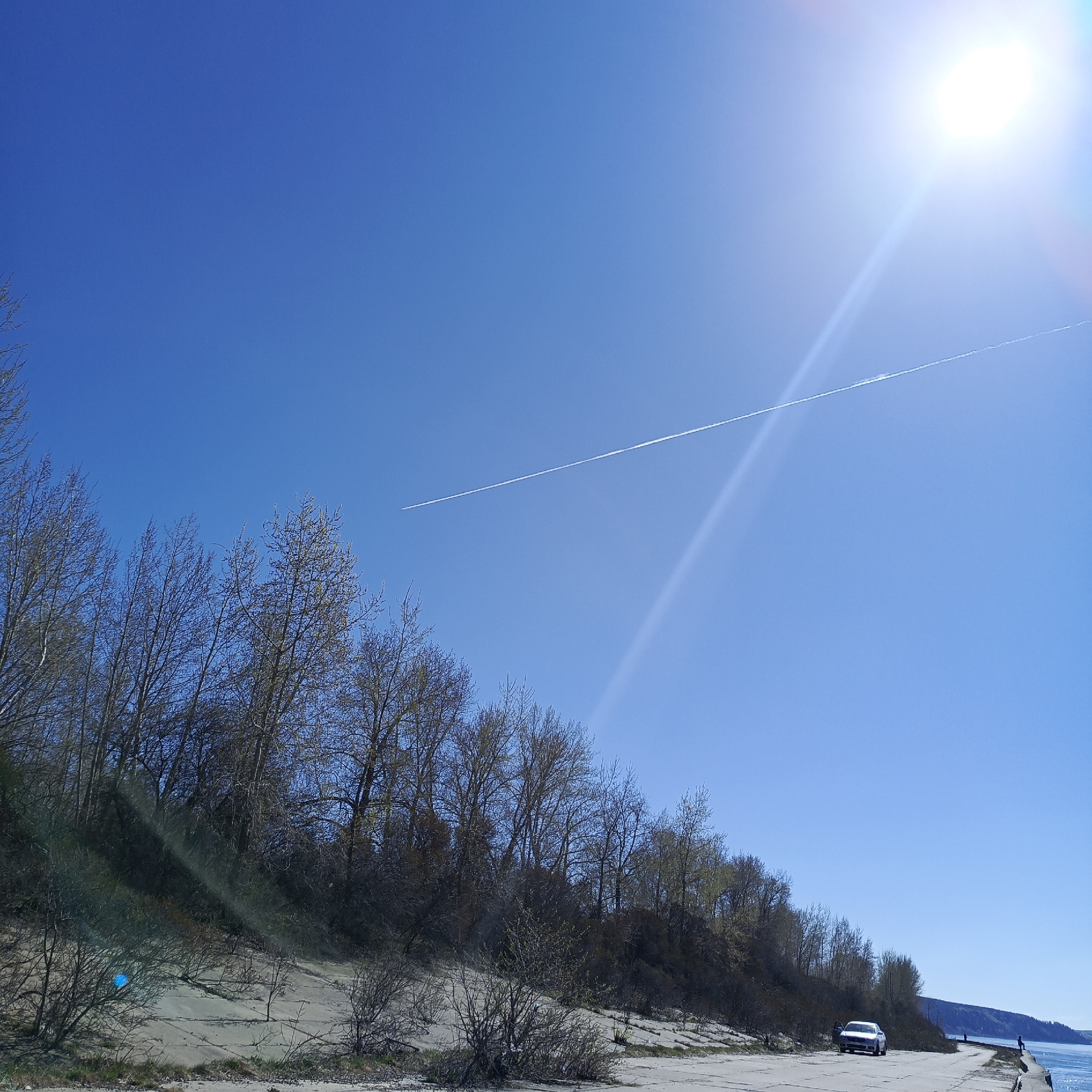 Woman and dog enjoy sunny morning along Kama River