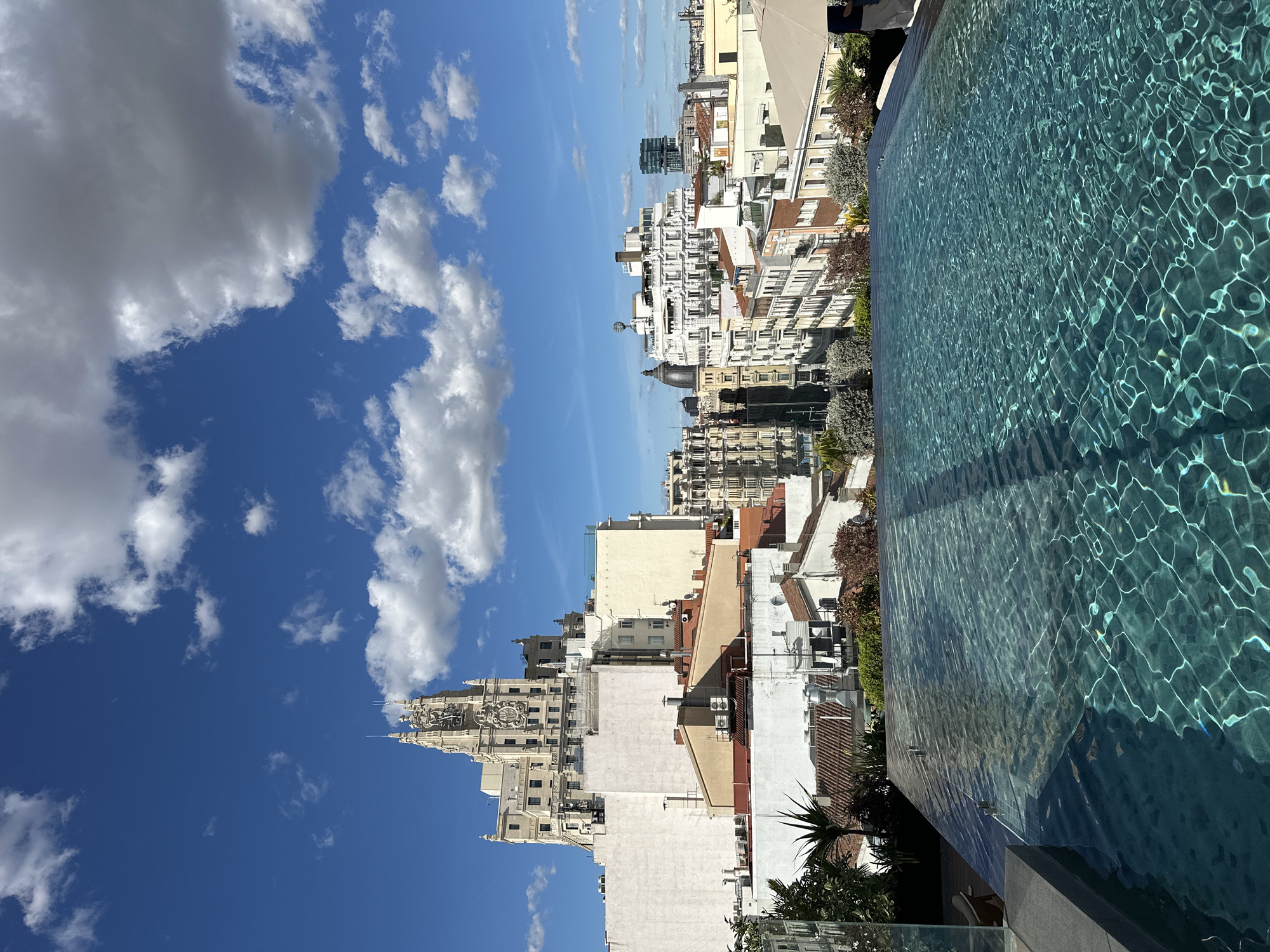 Rooftop pool overlooks Madrid on sunny afternoon