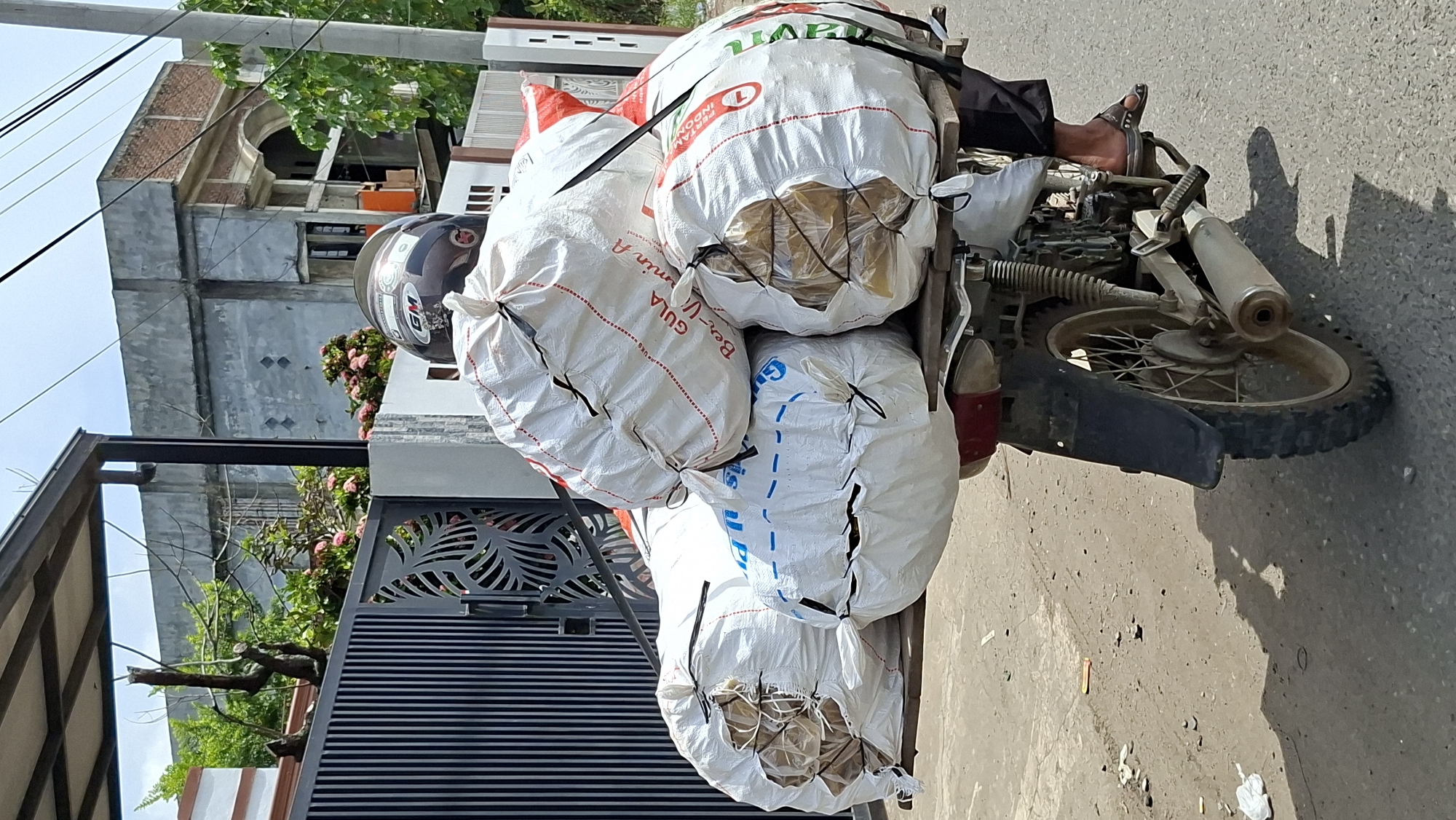 Motorcycles and trucks move goods through northern Aceh roads