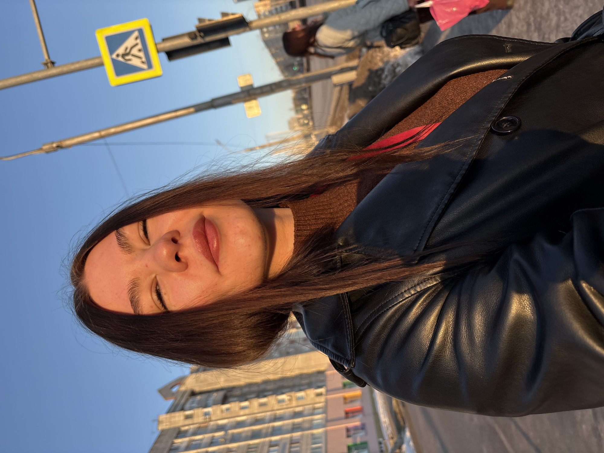 Woman takes selfies wearing Russian energy lanyard in Perm
