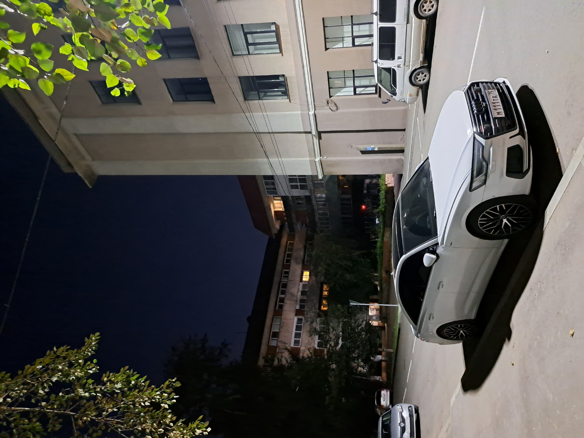 Nighttime streets in Irkutsk, parked cars and riverside at dusk