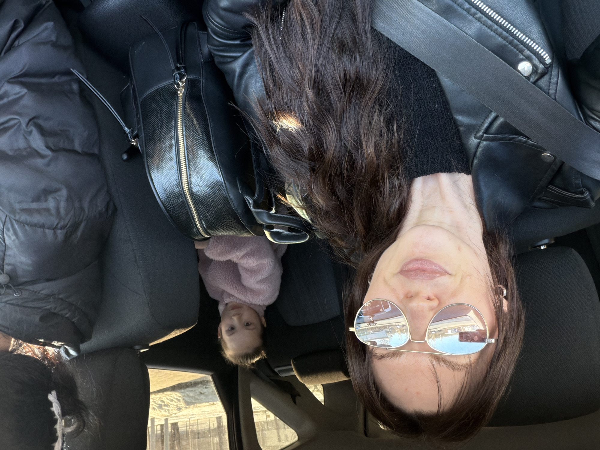 Woman and baby photographed in car backseat in Perm