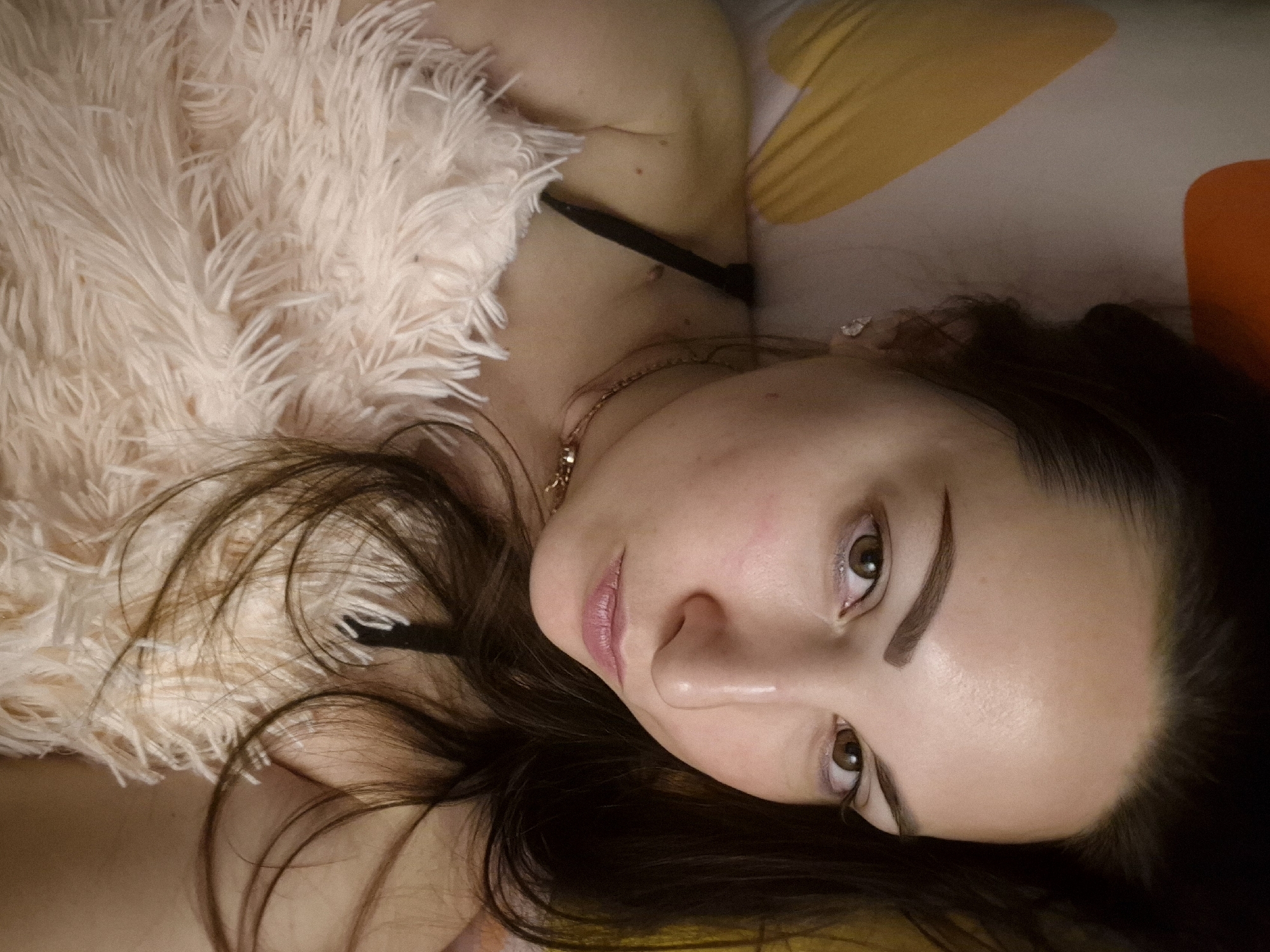 Woman photographed relaxing in bed with cat and plush toy