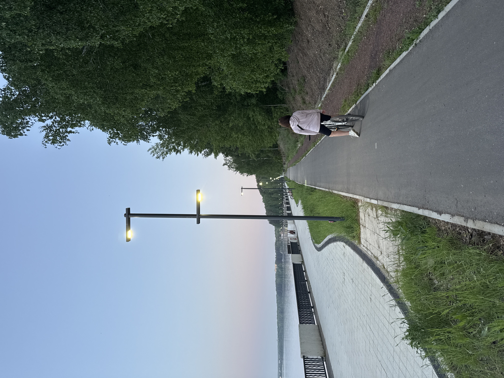Cyclist spotted on riverside path in Chaikovsky, Russia