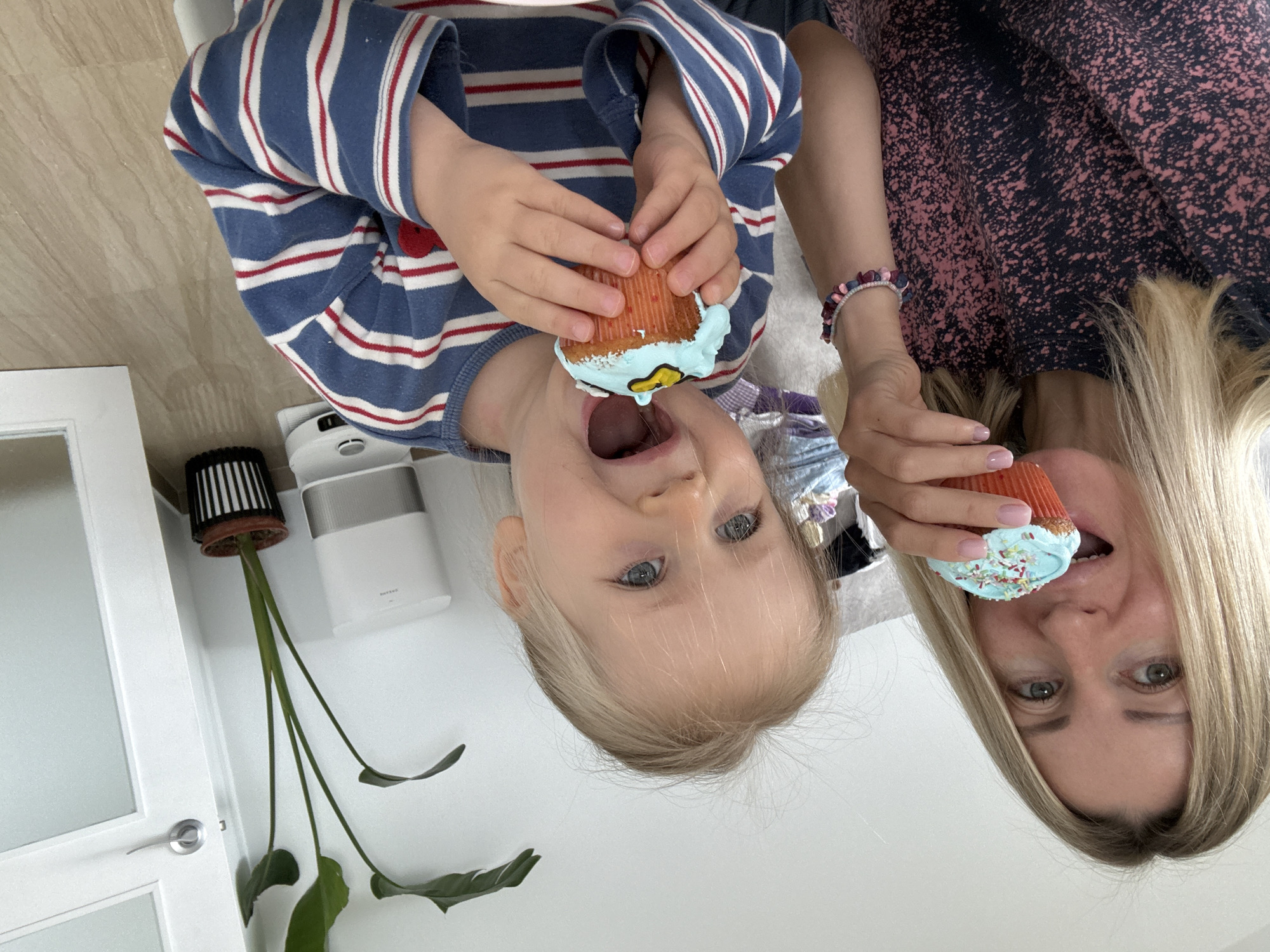 Woman and child pose upside down with cupcakes in València