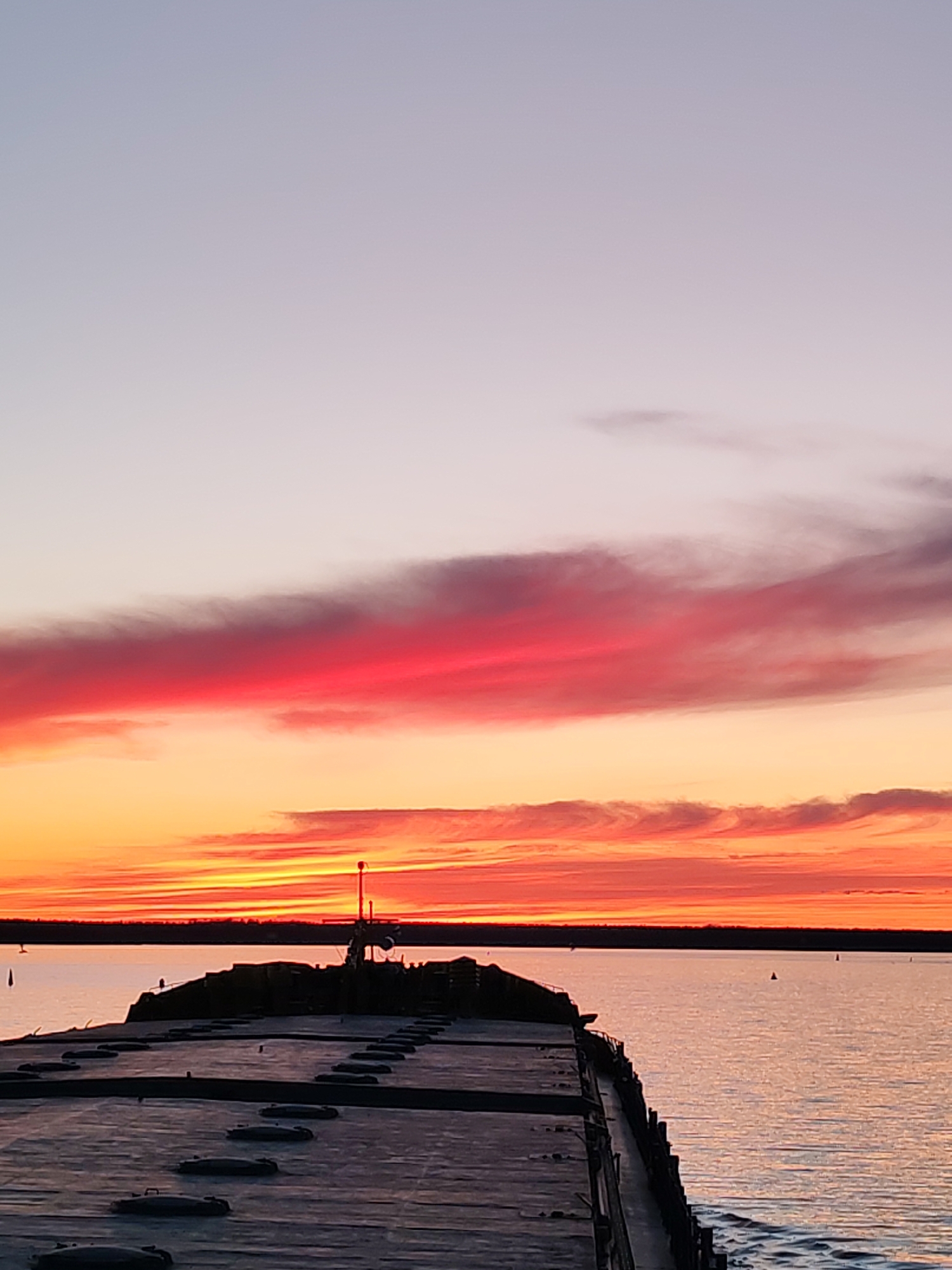 Sunset colors illuminate pier scene in Topornya, Russia