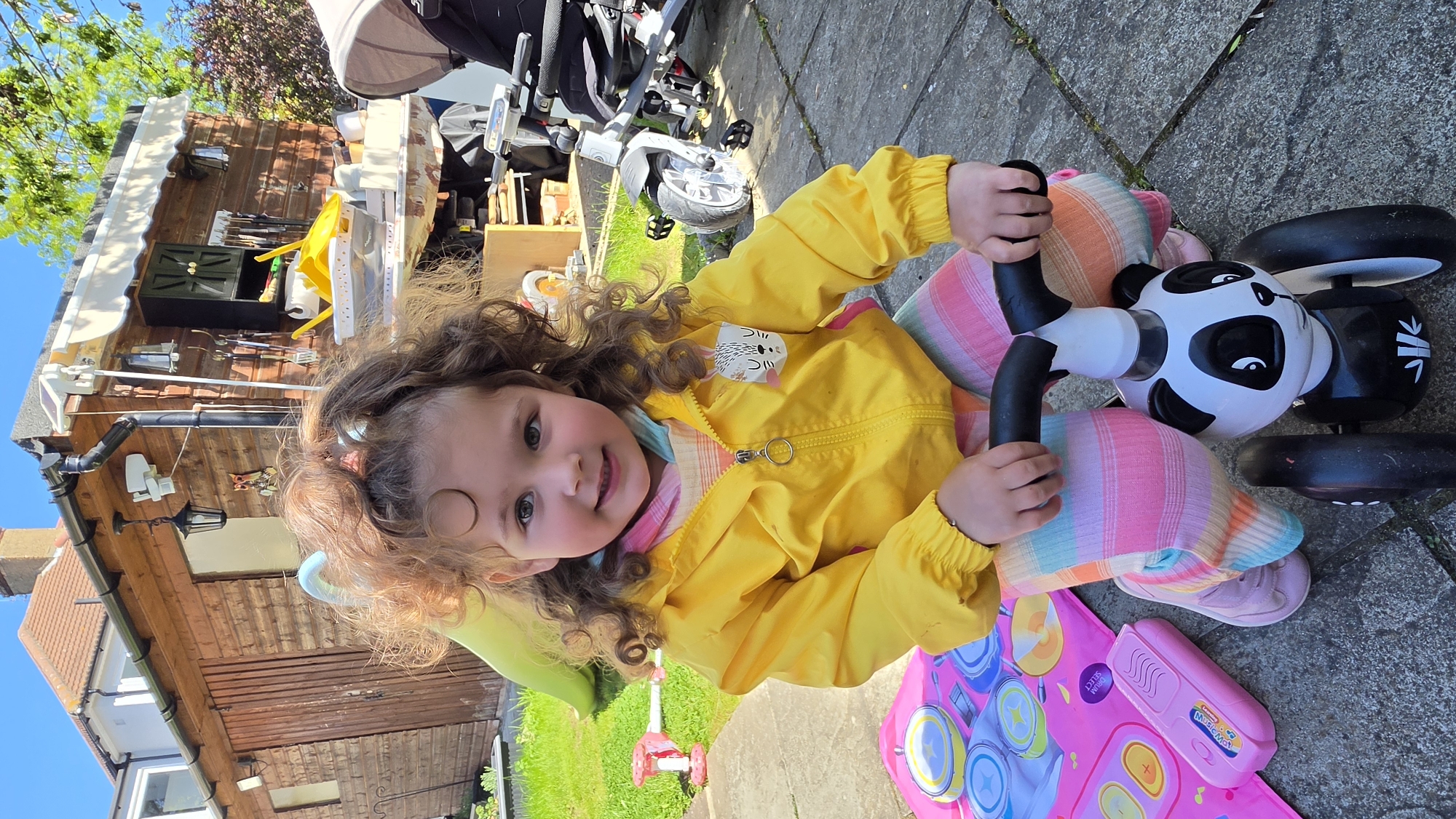 Child on panda tricycle, tabby cat spotted in London