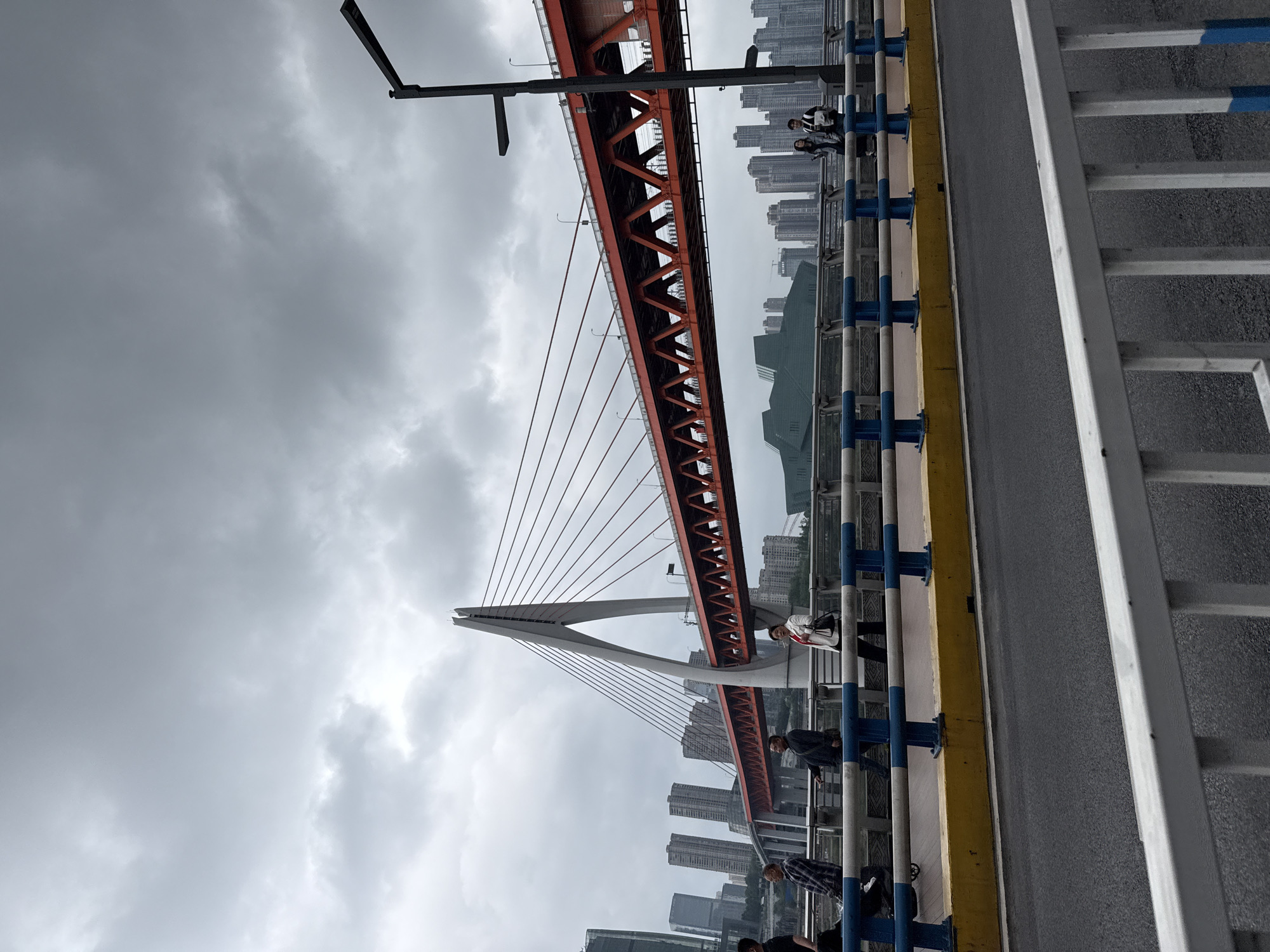 Pedestrian captures red bridge view in Yuzhong District