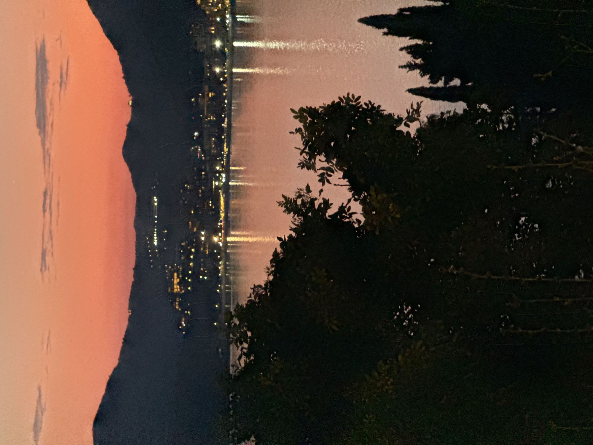 Sunset over the Montenegro coast, mountains and city lights