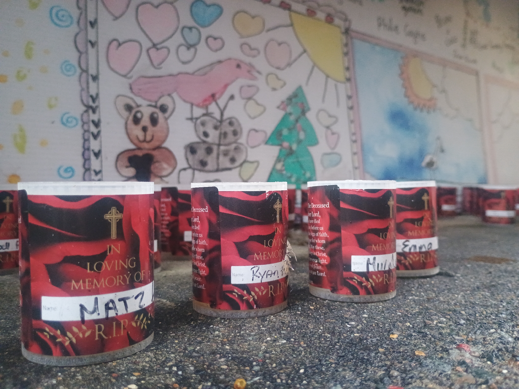Street scenes and roadside memorial candles in a rainy Irish town