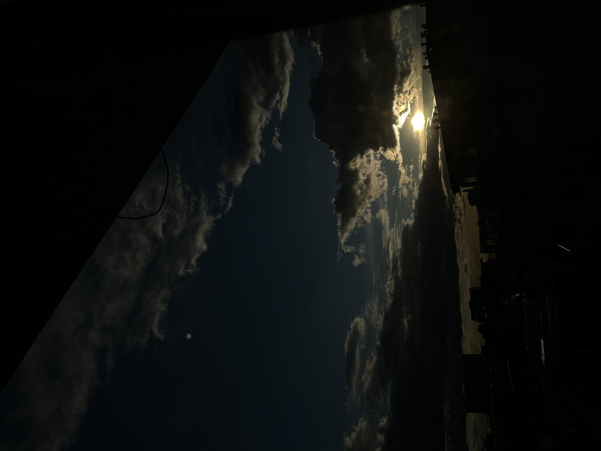 Dramatic sunset photographed over city skyline during evening hours