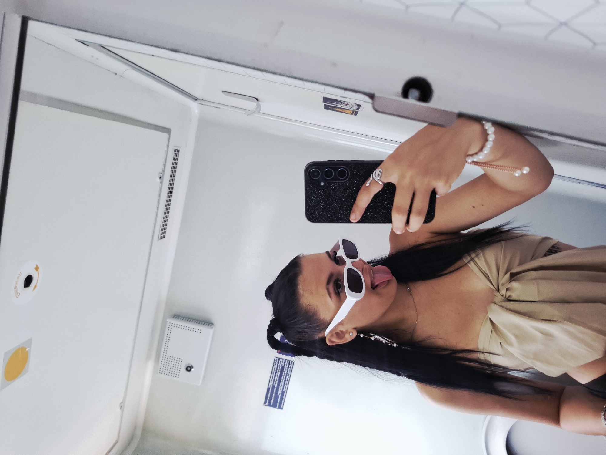 Woman takes playful selfie in transport restroom near Karlukovo
