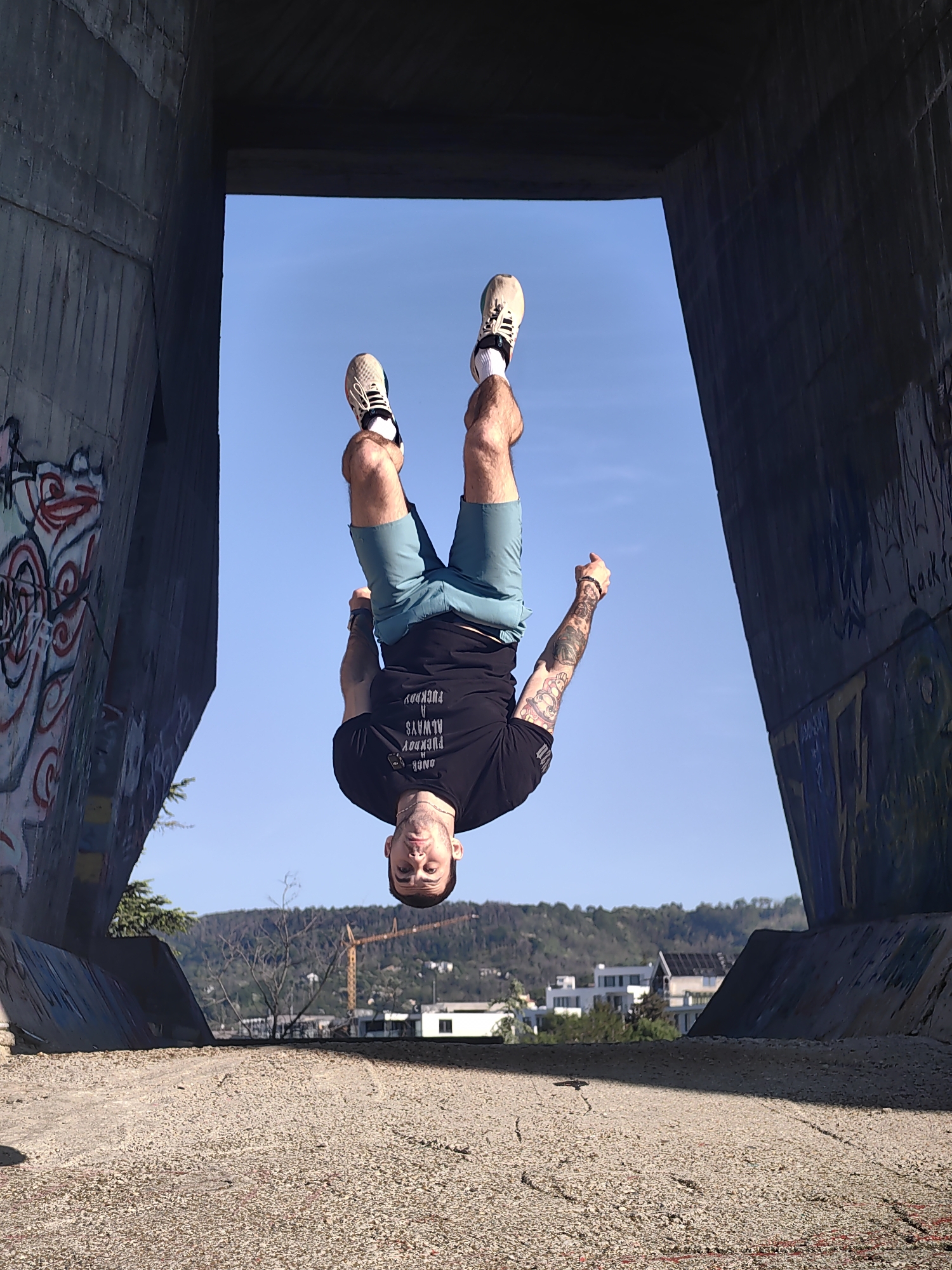 Man performs backflip under concrete bridge in Varna, Bulgaria