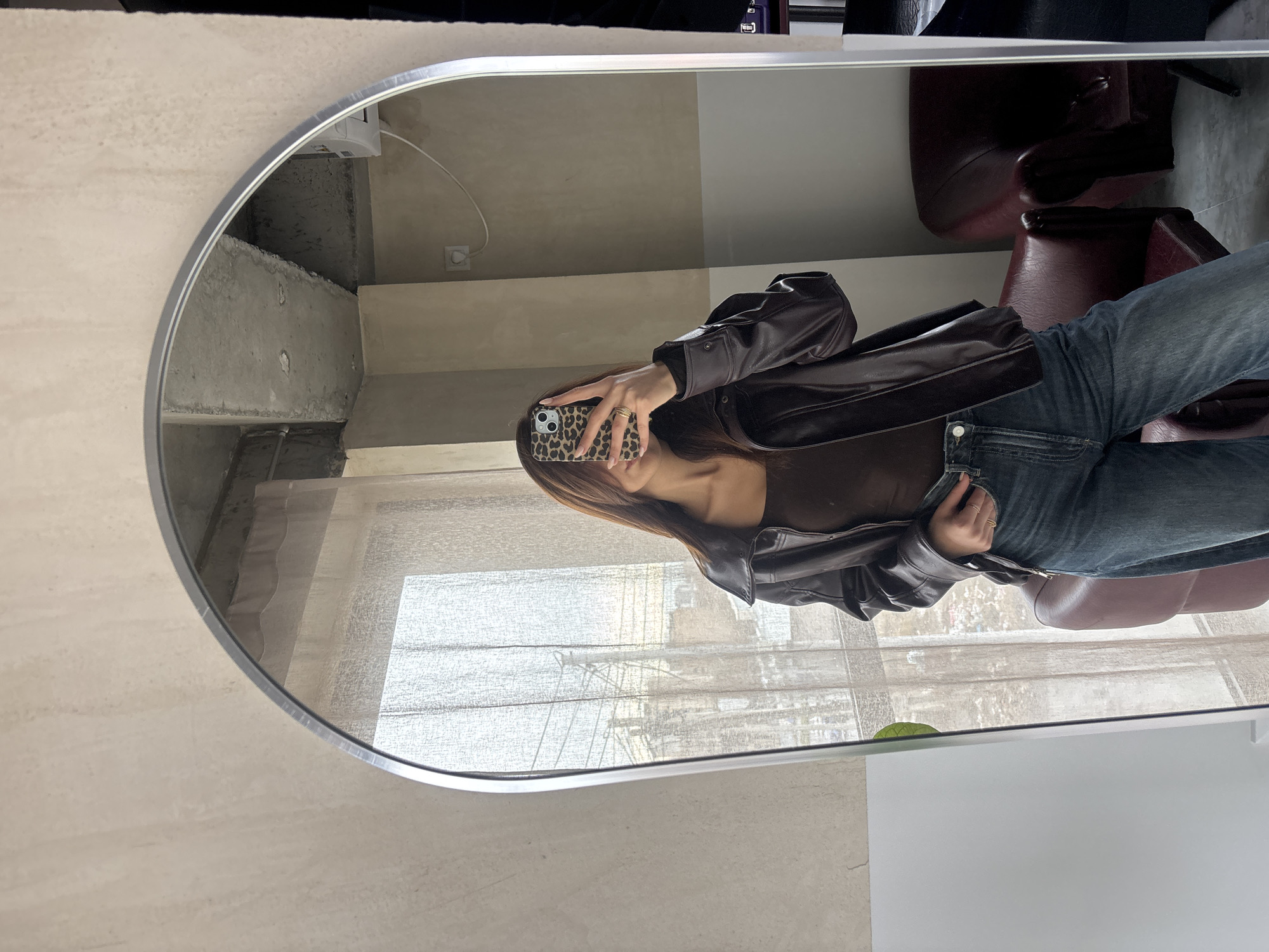 Woman takes morning selfies in brown leather jacket, Yerevan