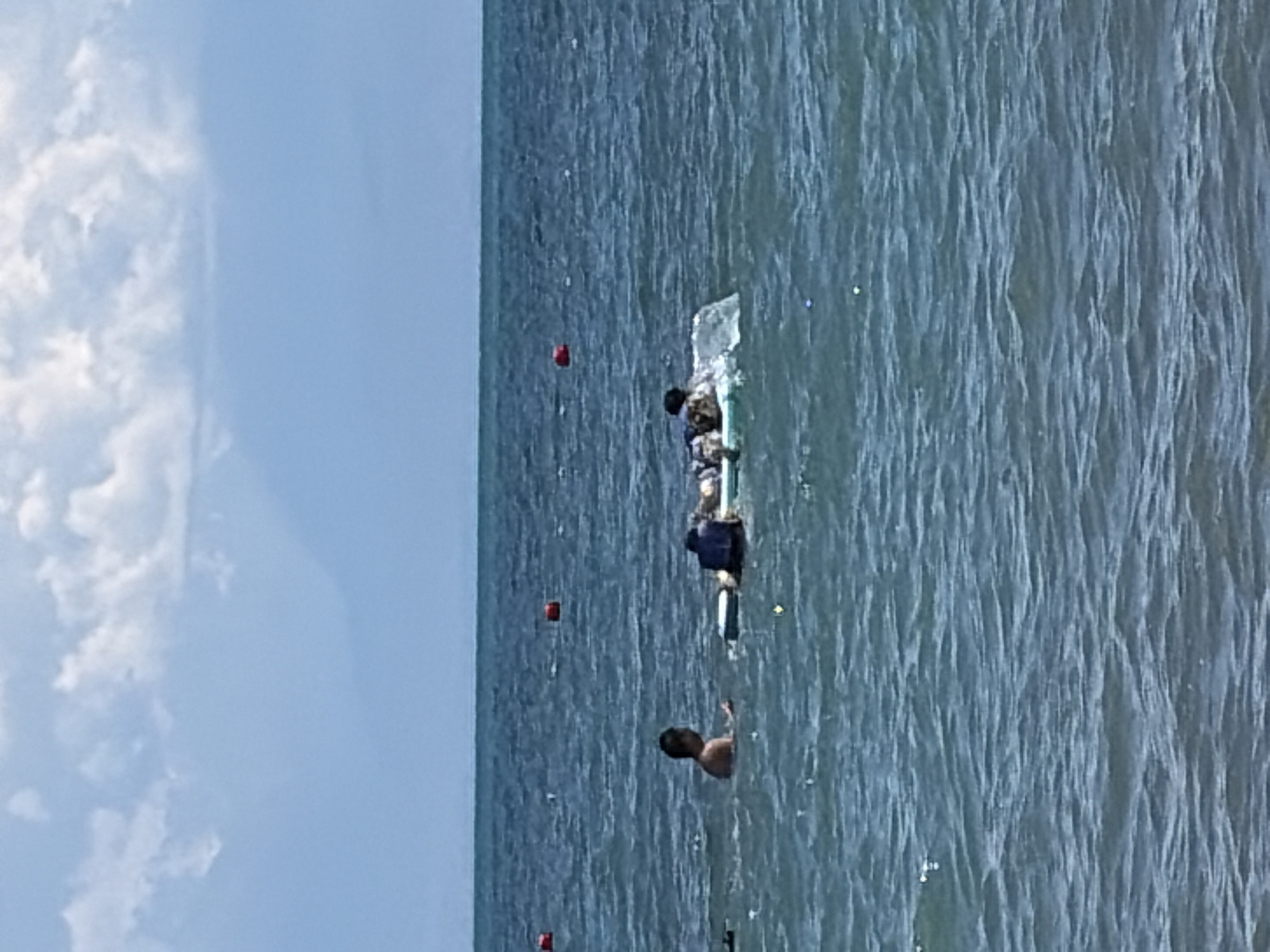 A relaxed beach day with swimming, paddleboarding, and shoreside lounging.