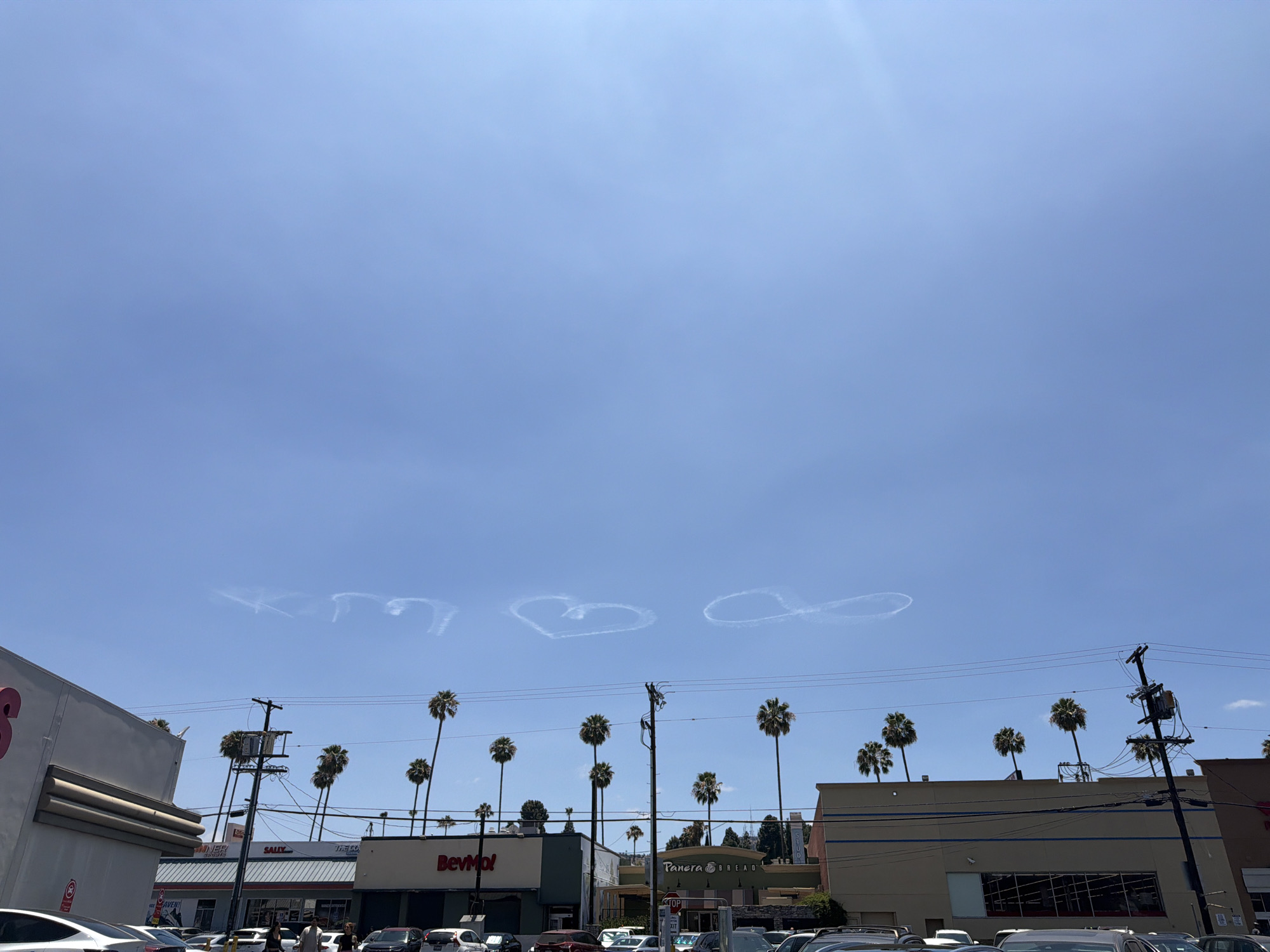 LA street market buzzes under heart-shaped contrails