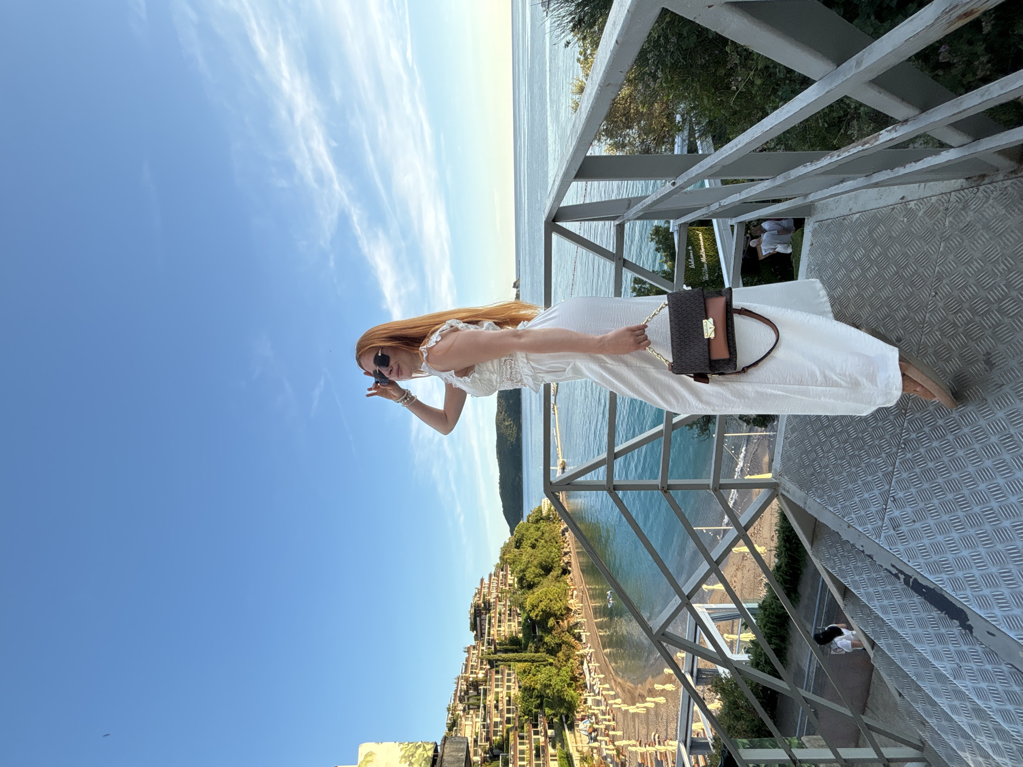 Woman walks dog during golden hour in Budva Montenegro