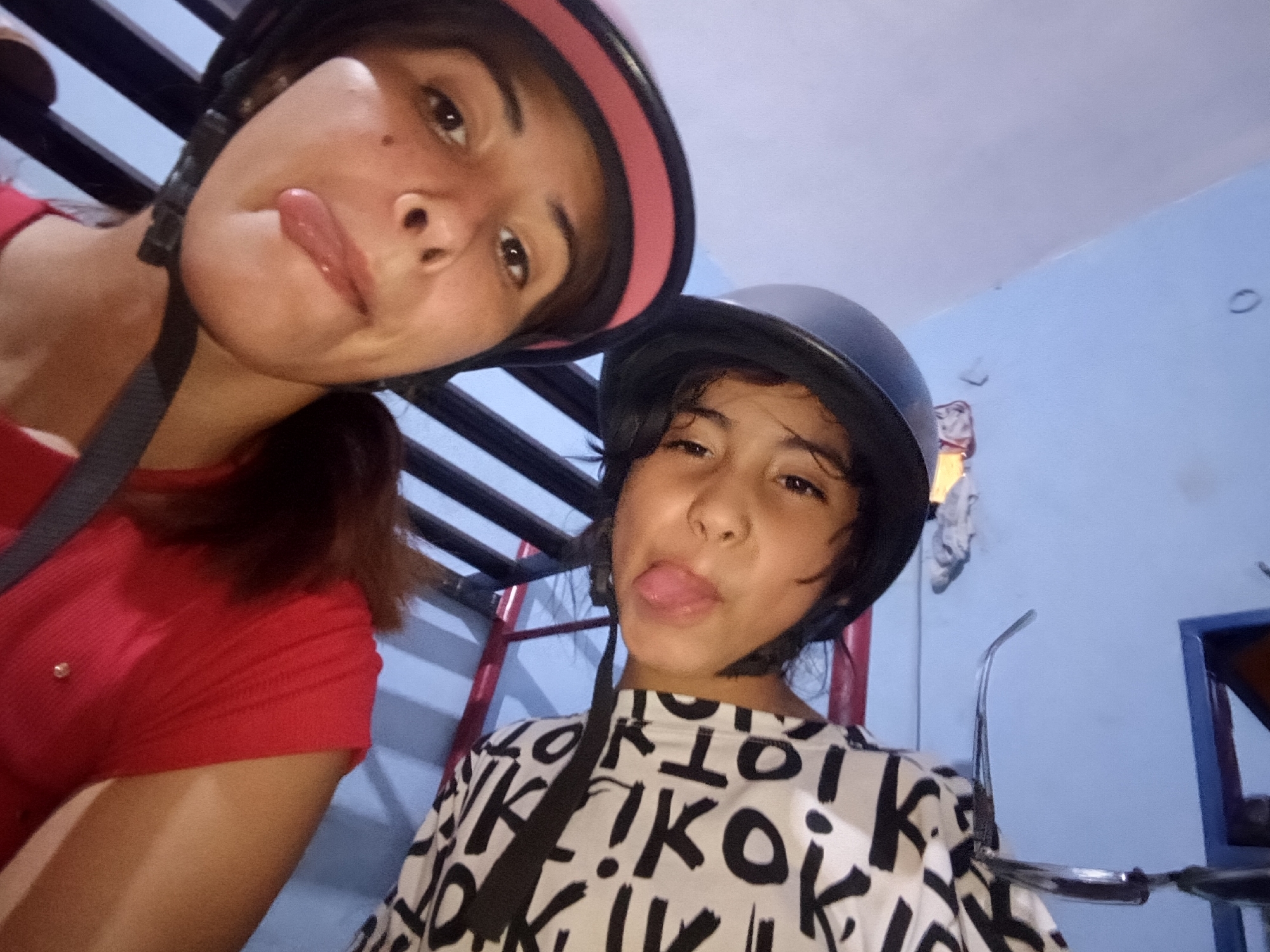 Helmet-wearing duo takes selfies in Juan Griego, Venezuela