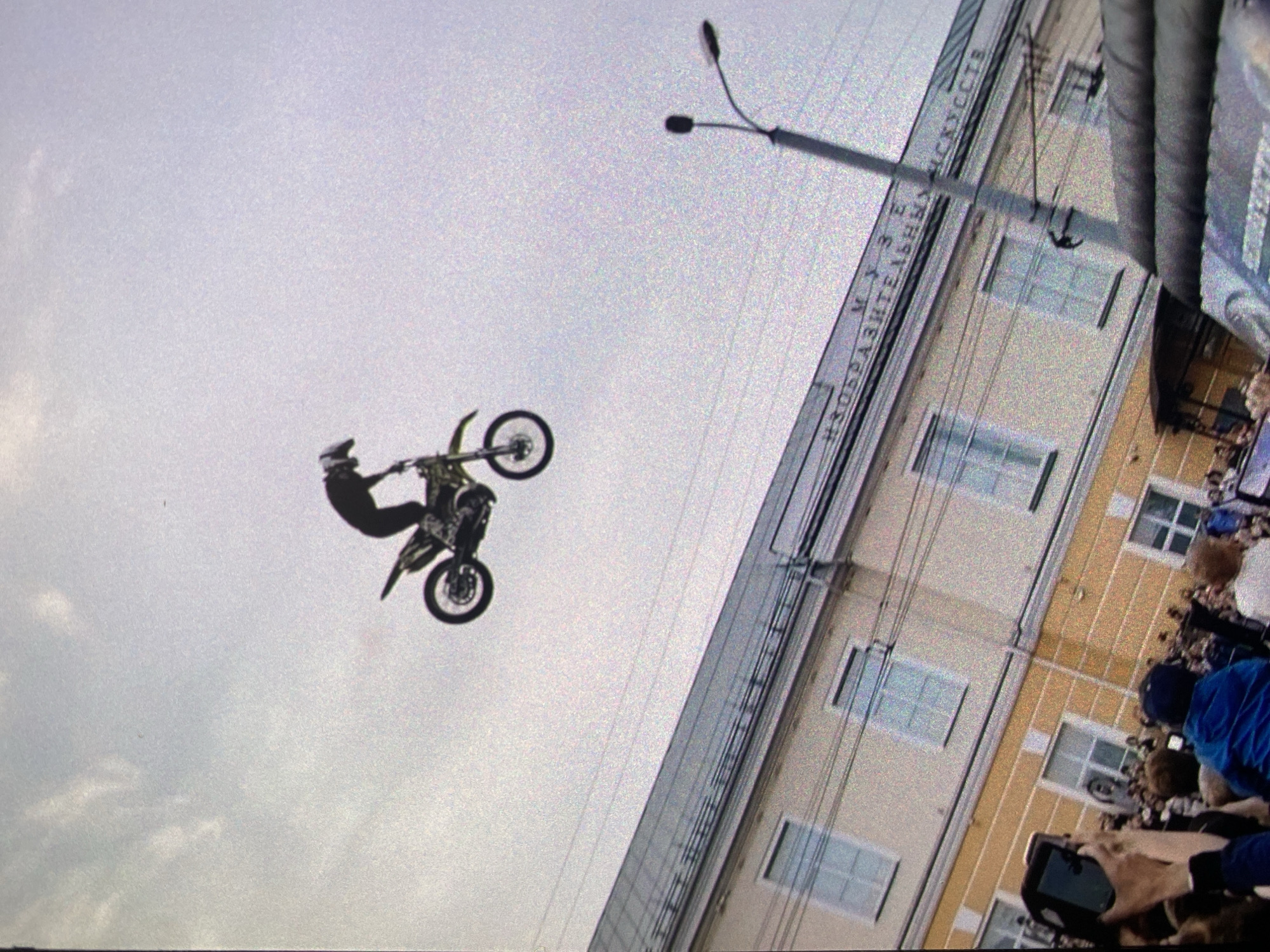 Motocross stunt jump against overcast sky backdrop