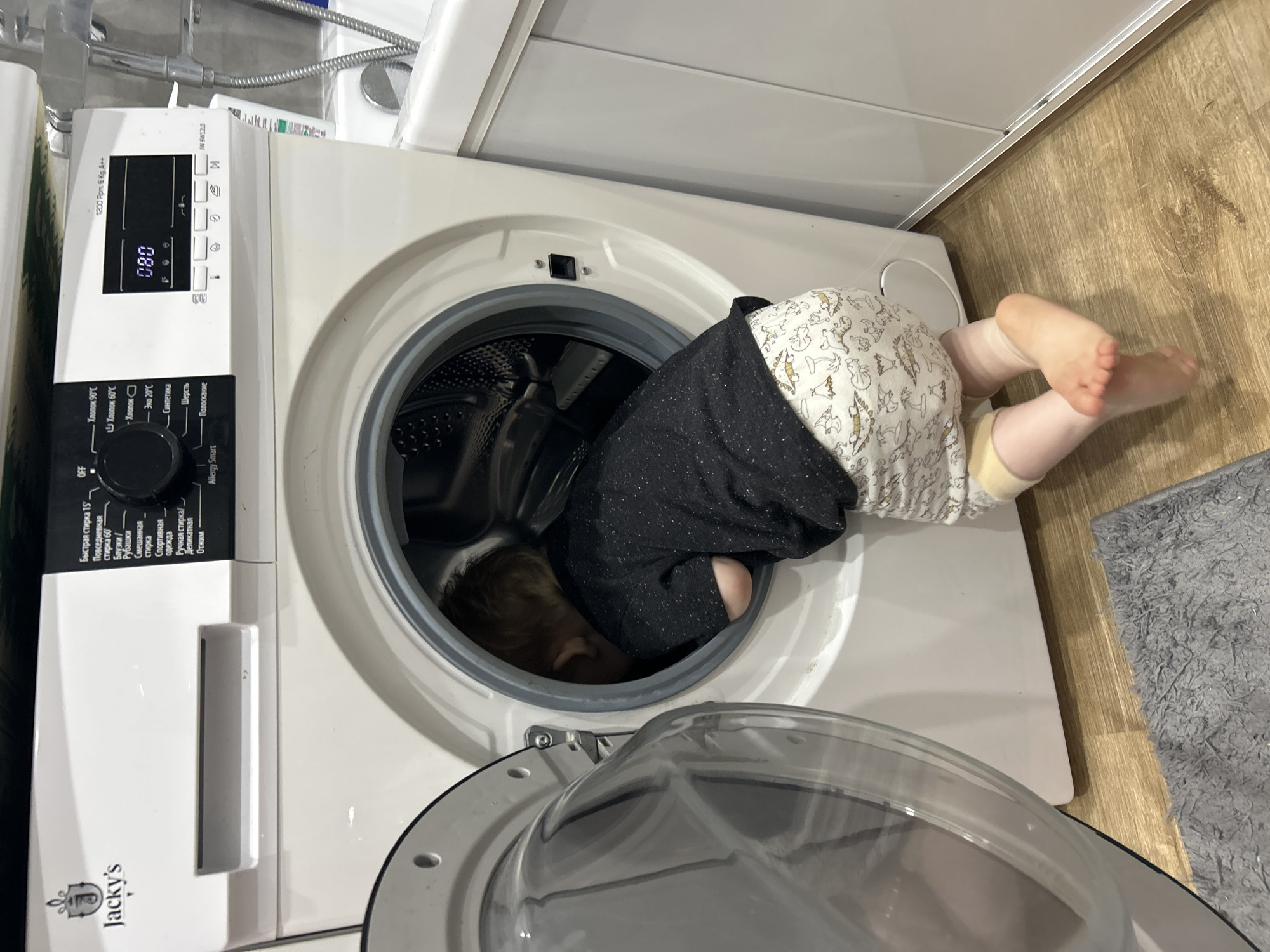 Family playtime documented in Chaikovsky home, child explores washing machine