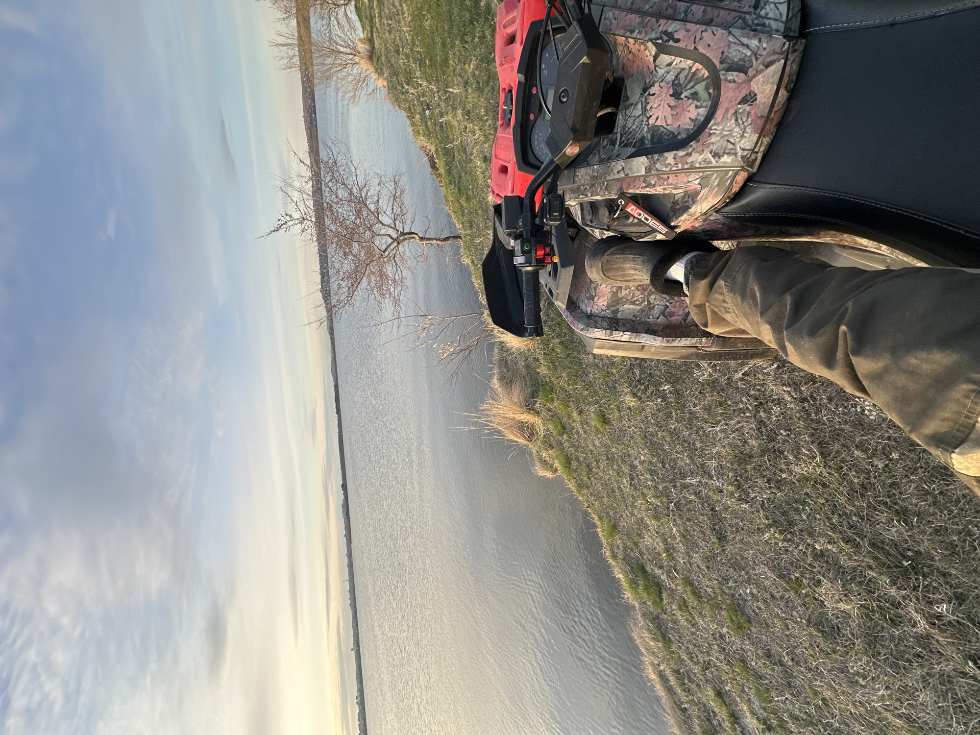 Recreational outing near water documented with ATV and sunset