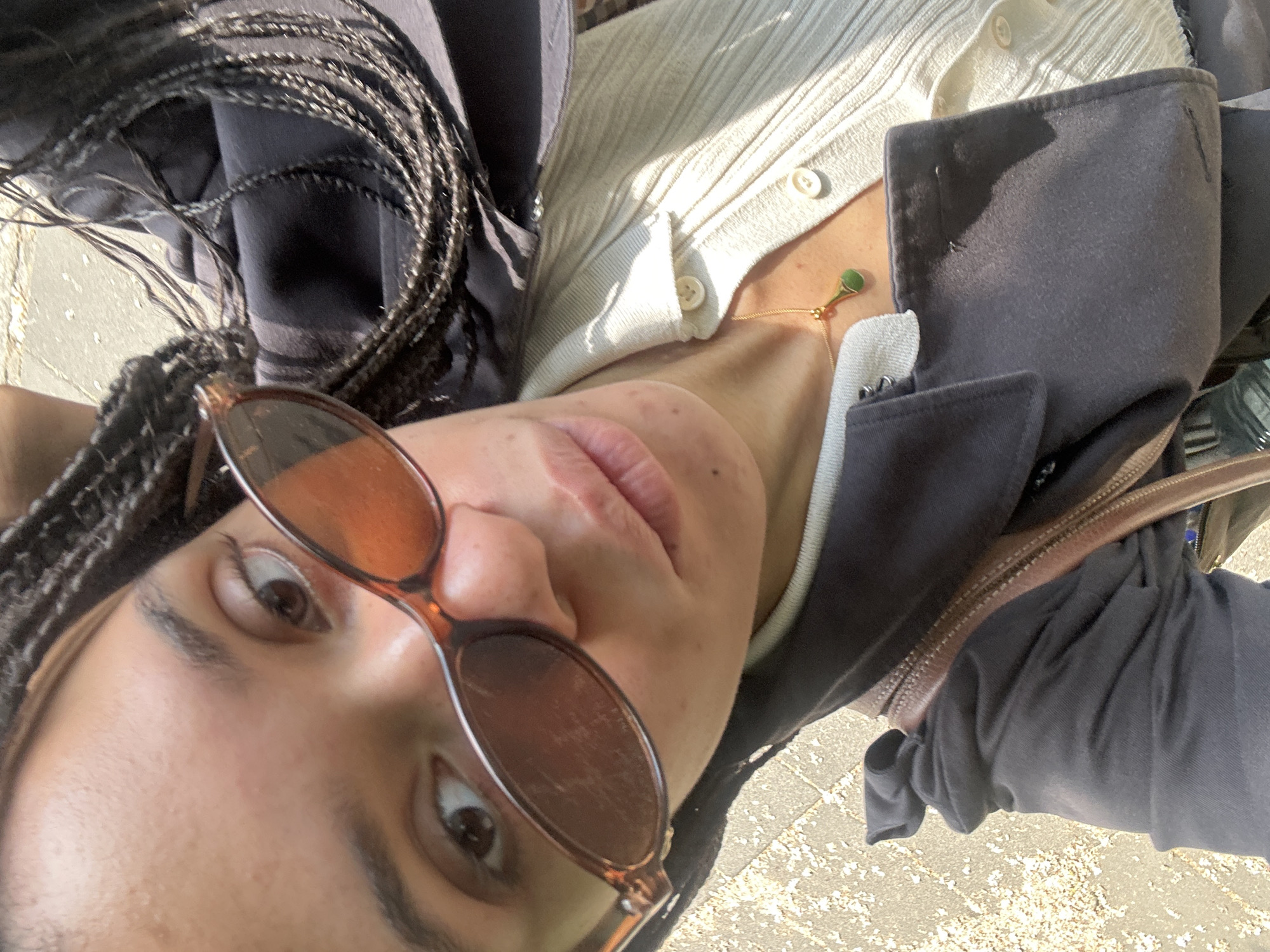 Woman in sunglasses photographed from ground level in London