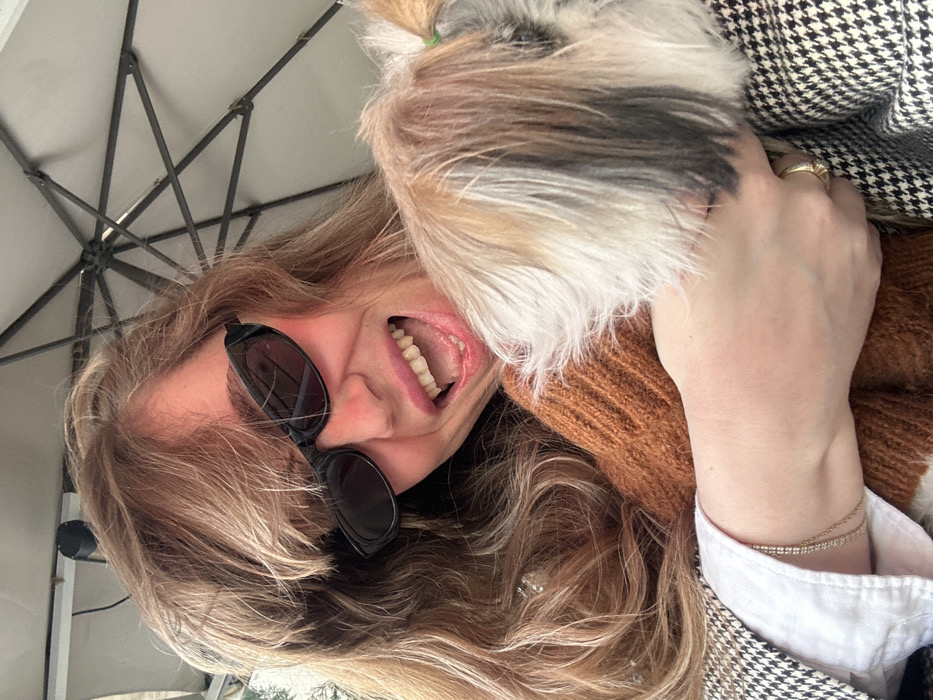 Woman and dressed dog enjoy leisurely cafe morning in Tbilisi