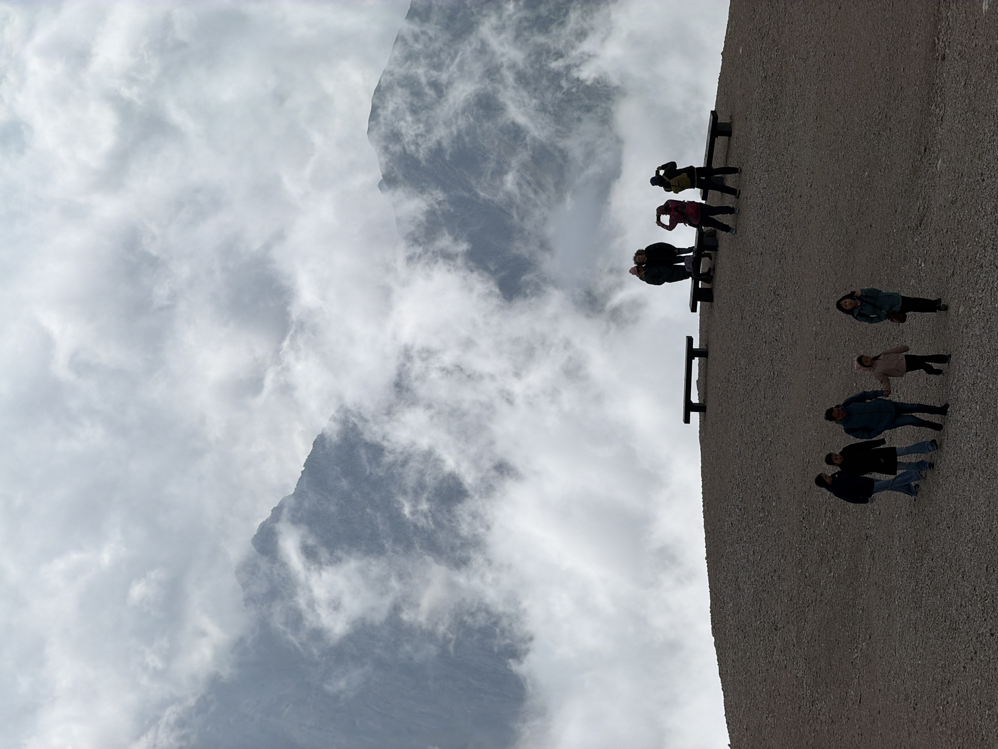 Group pauses on a cloud-wrapped alpine ridge in Wildermieming