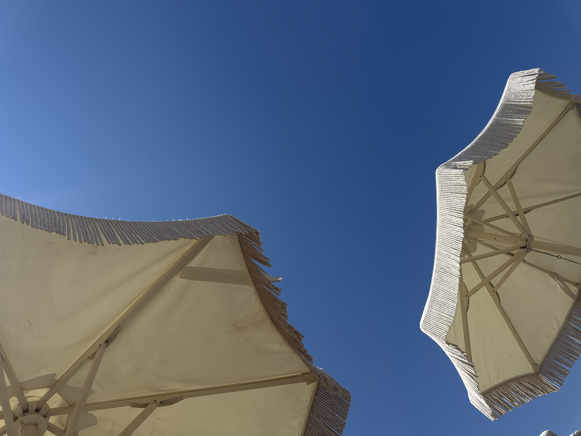 Lazy summer afternoon on a Greek beach with book and shade