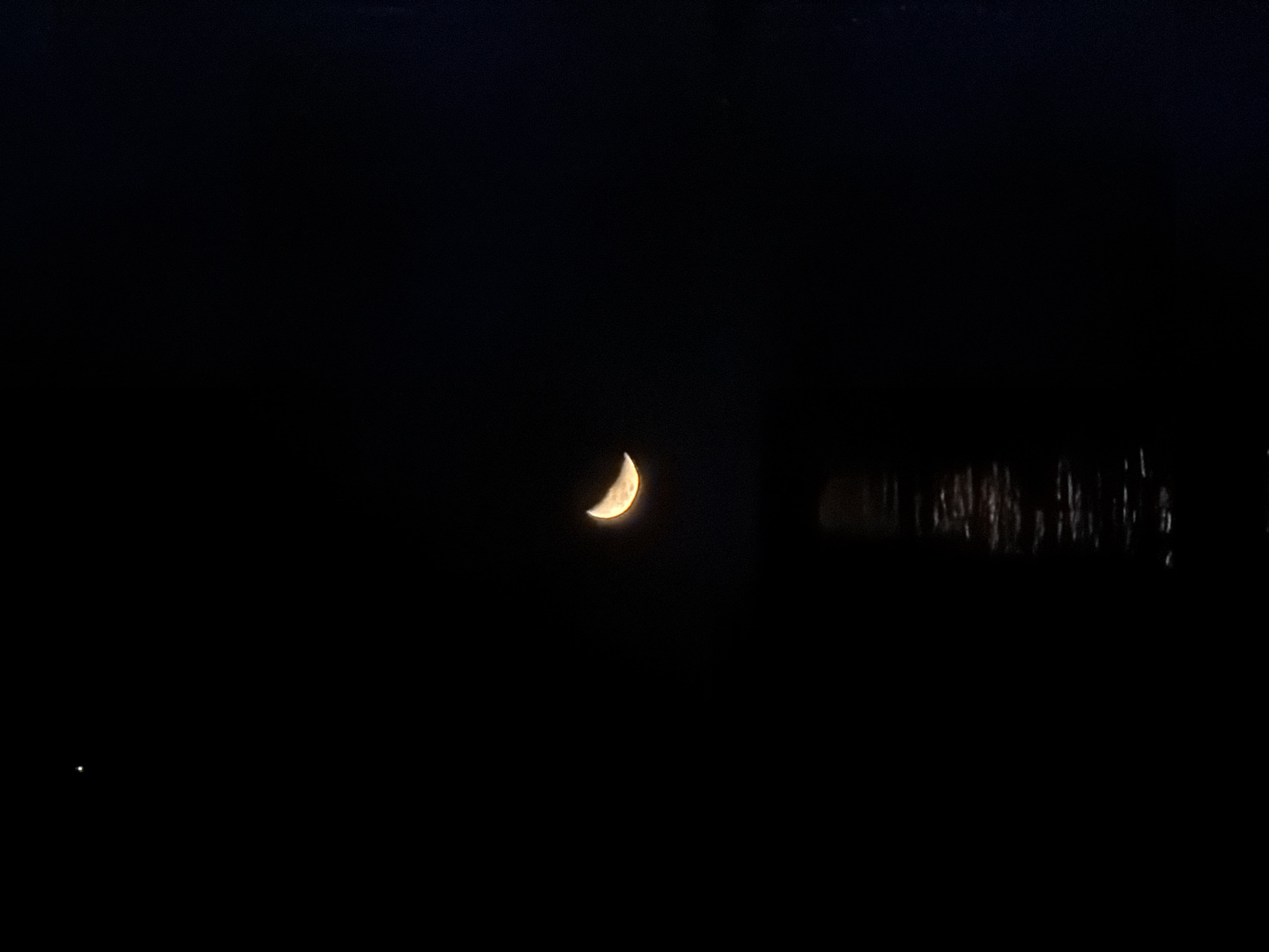 Crescent moon observed over Cape Town with water reflections