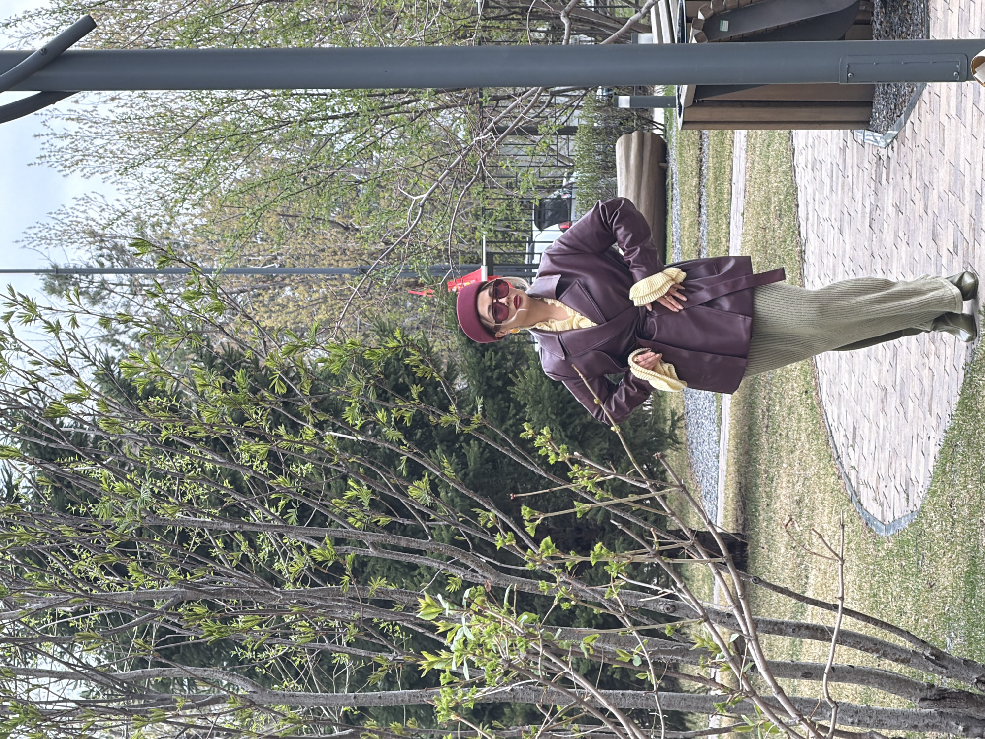 Woman in burgundy outfit photographed in Krasnoyarsk park