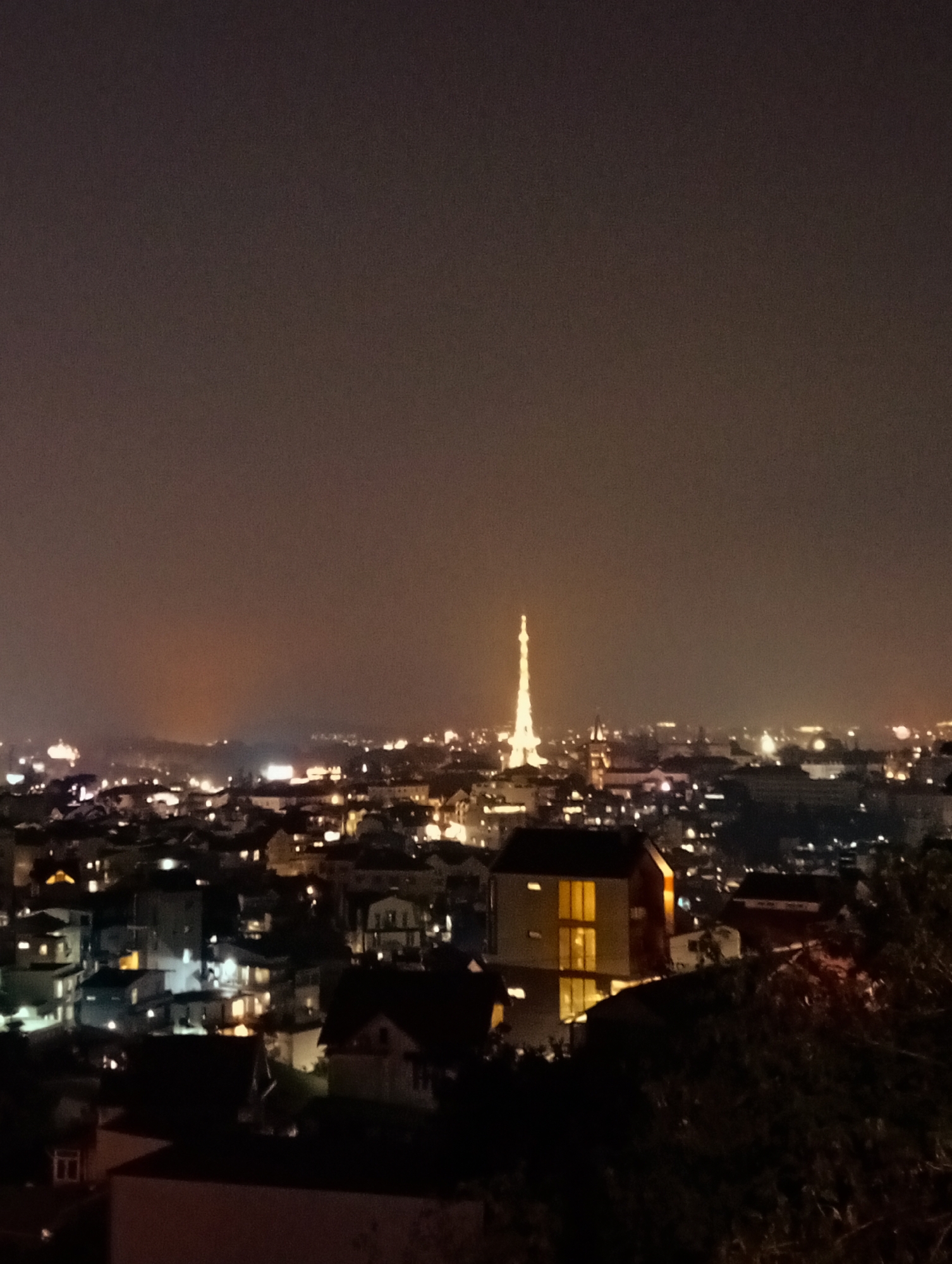 Nighttime aerial views capture Da Lat cityscape with radio tower