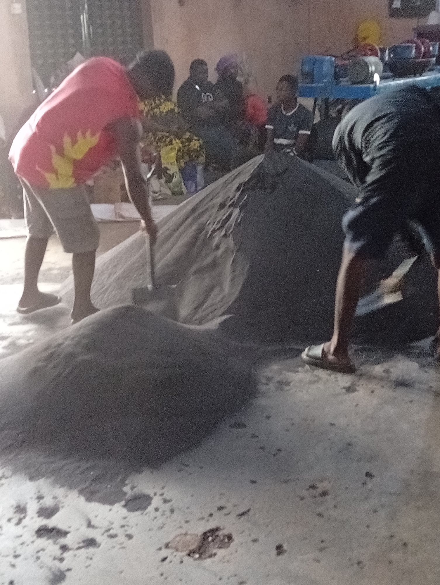 Workers handle sand, materials in Gura Top warehouse operation