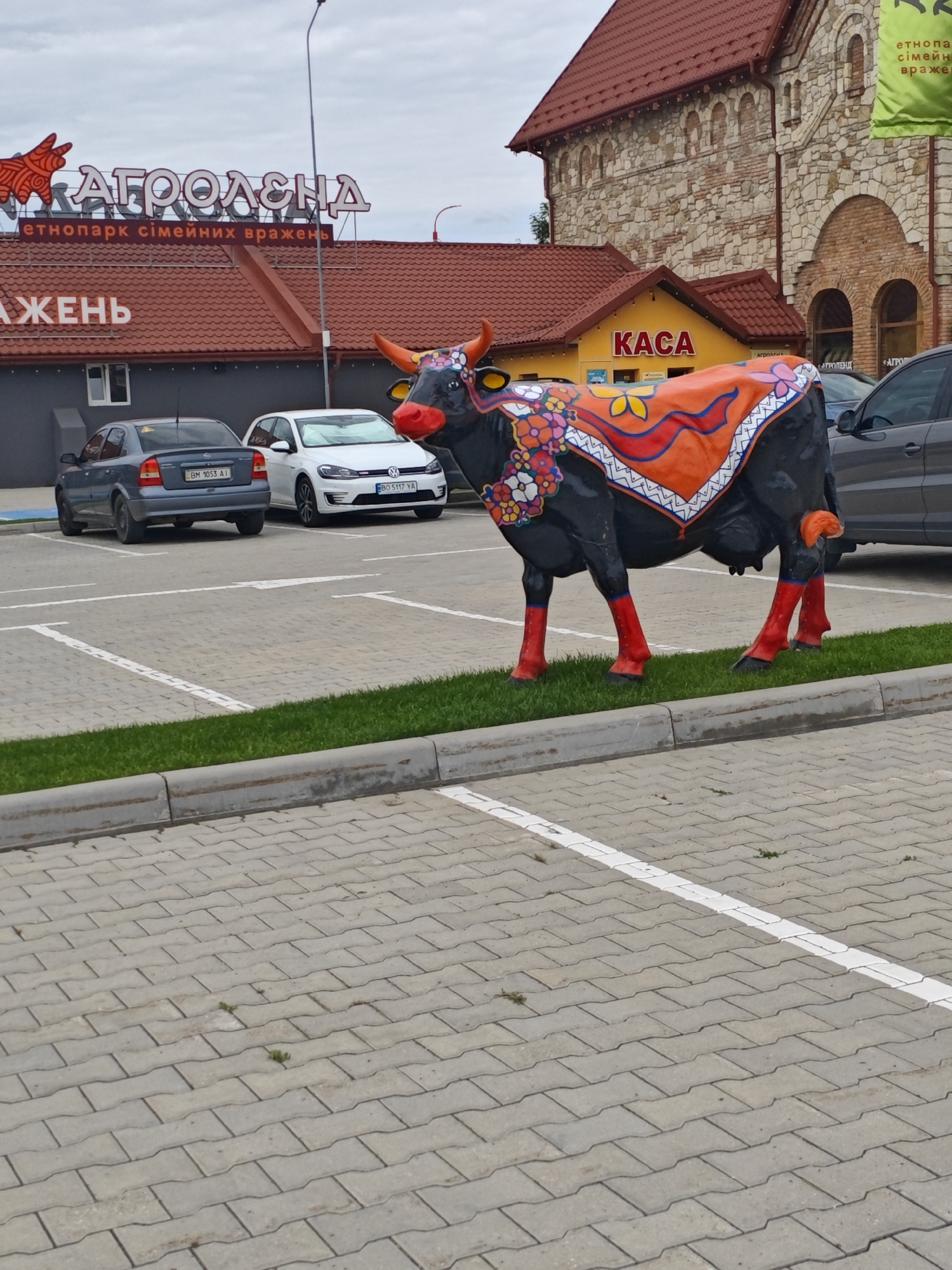 Farm park visit: animals, petting zoo enclosures, and cow sculptures