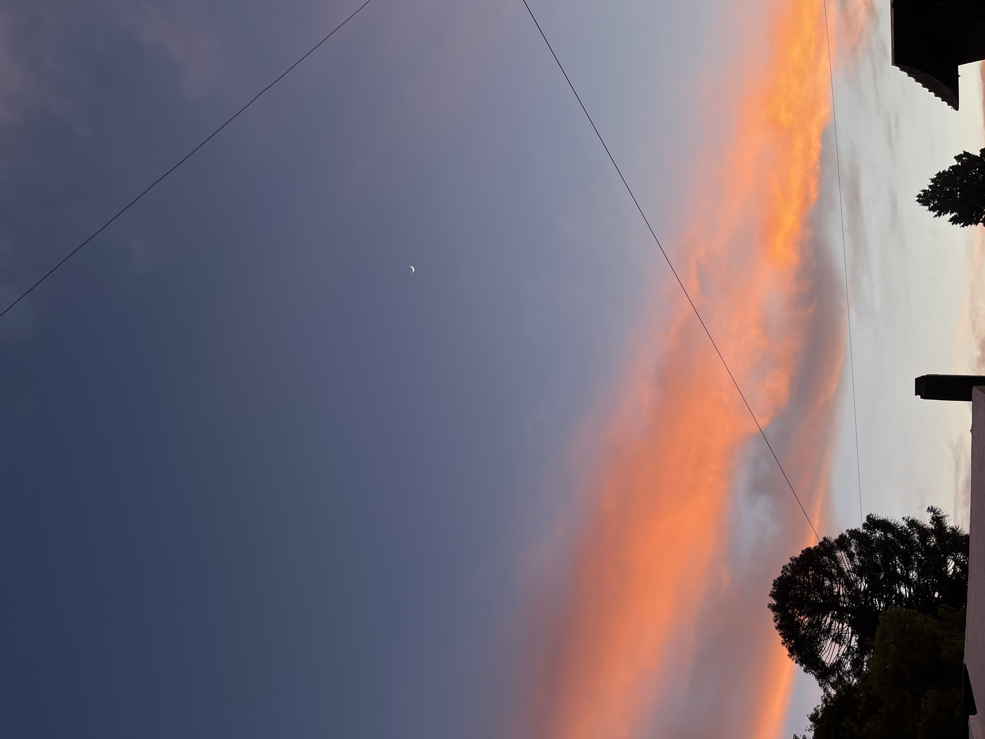 Crescent moon spotted over Cordoba residential area at twilight