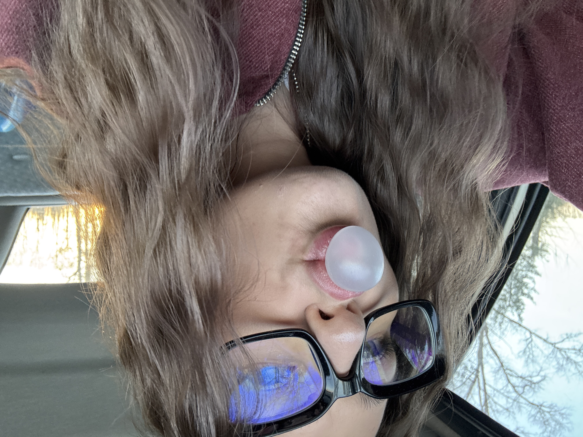 Person with glasses photographed blowing something in Rusalevka