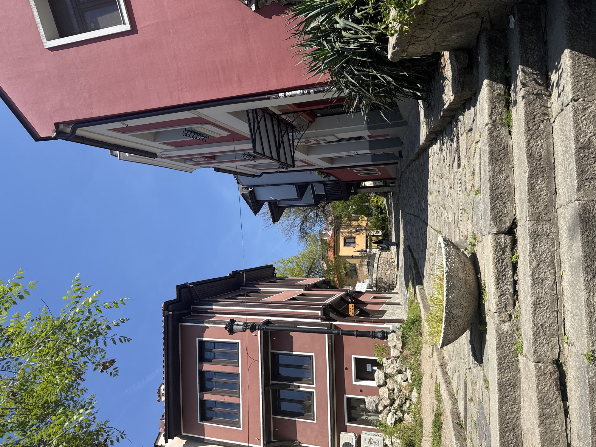 Tourists explore historic Plovdiv Old Town cobblestone streets