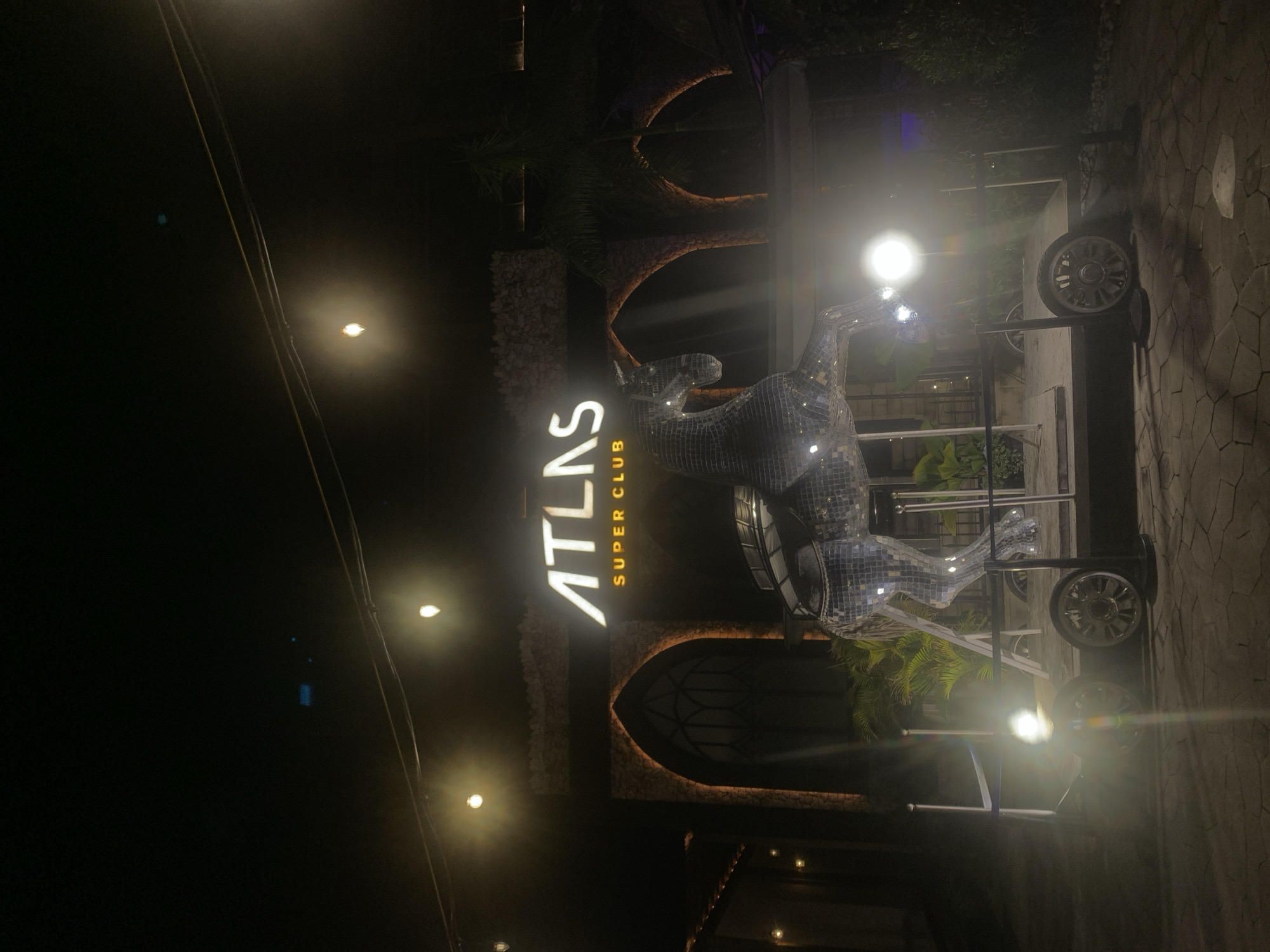 Atlas Super Club entrance illuminated at night in North Kuta
