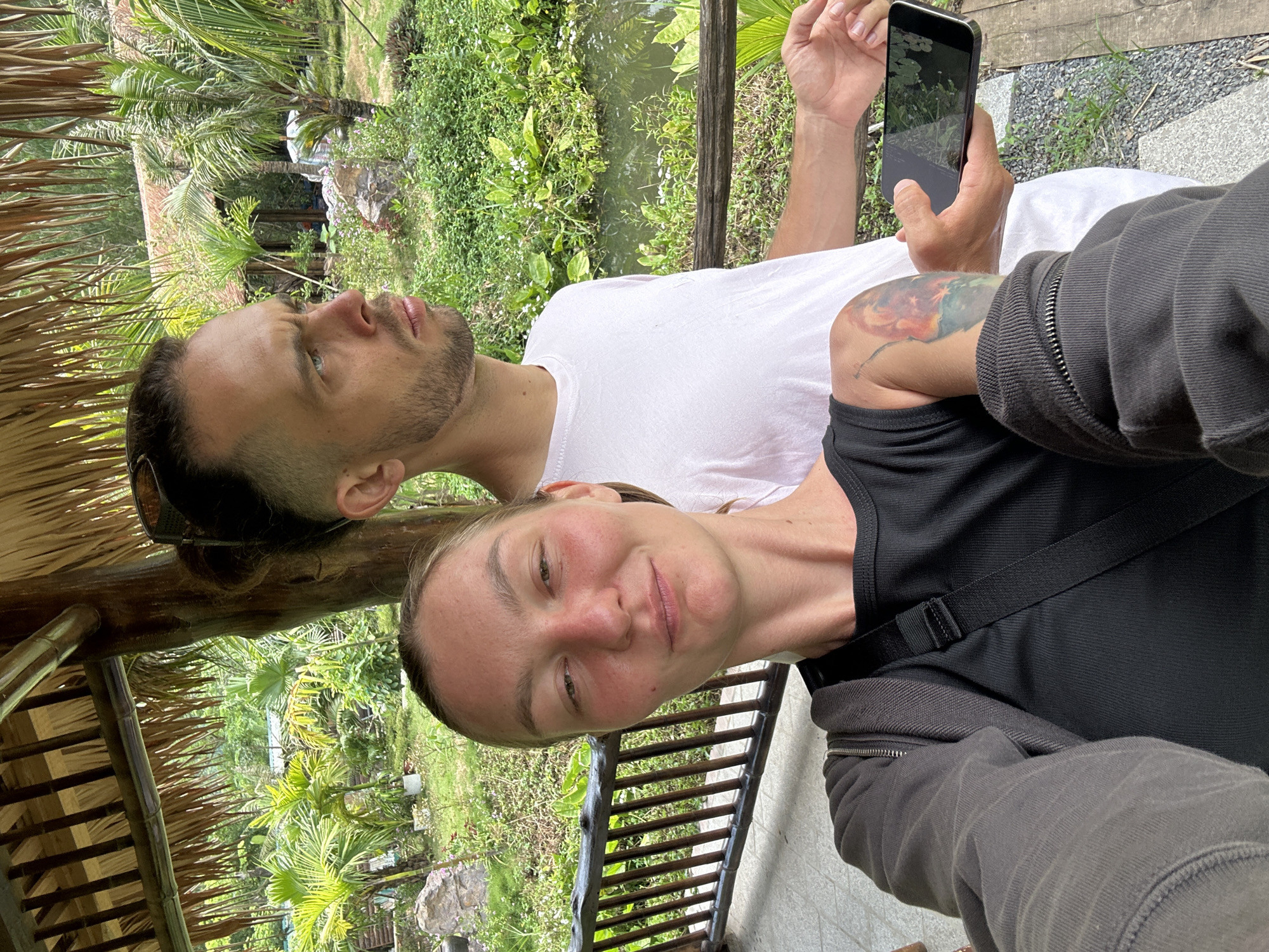 Woman photographs tropical resort visit in Vietnam early morning