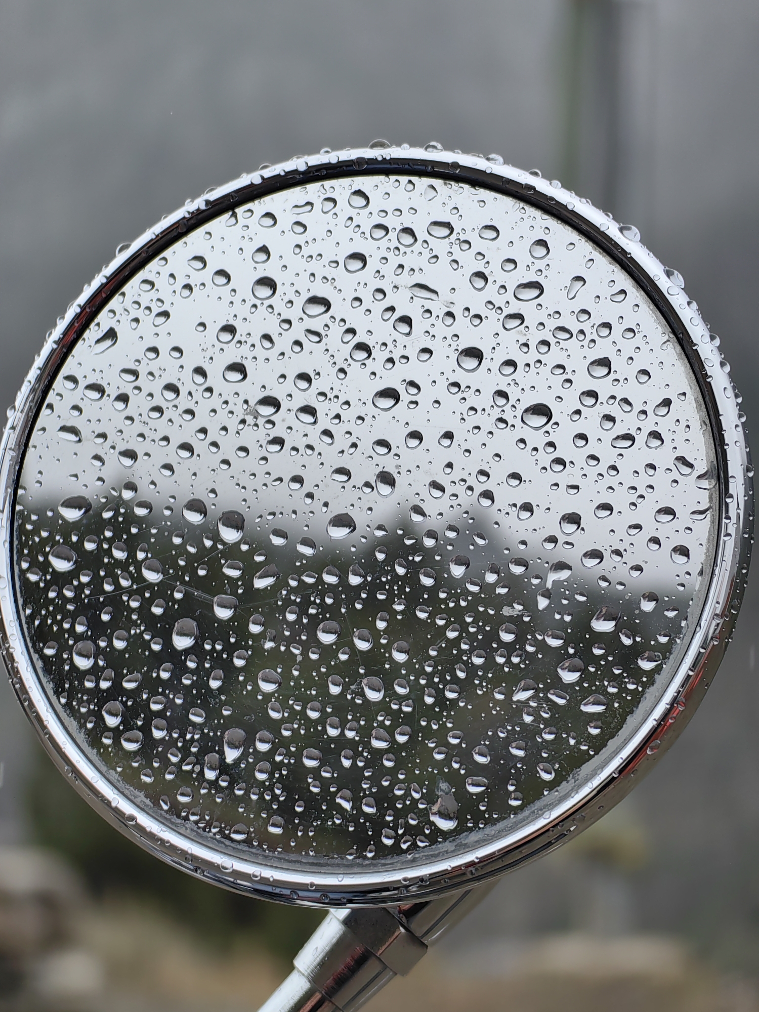 Wet day pit stop in Spiti Valley, motorcycles and mountain views.