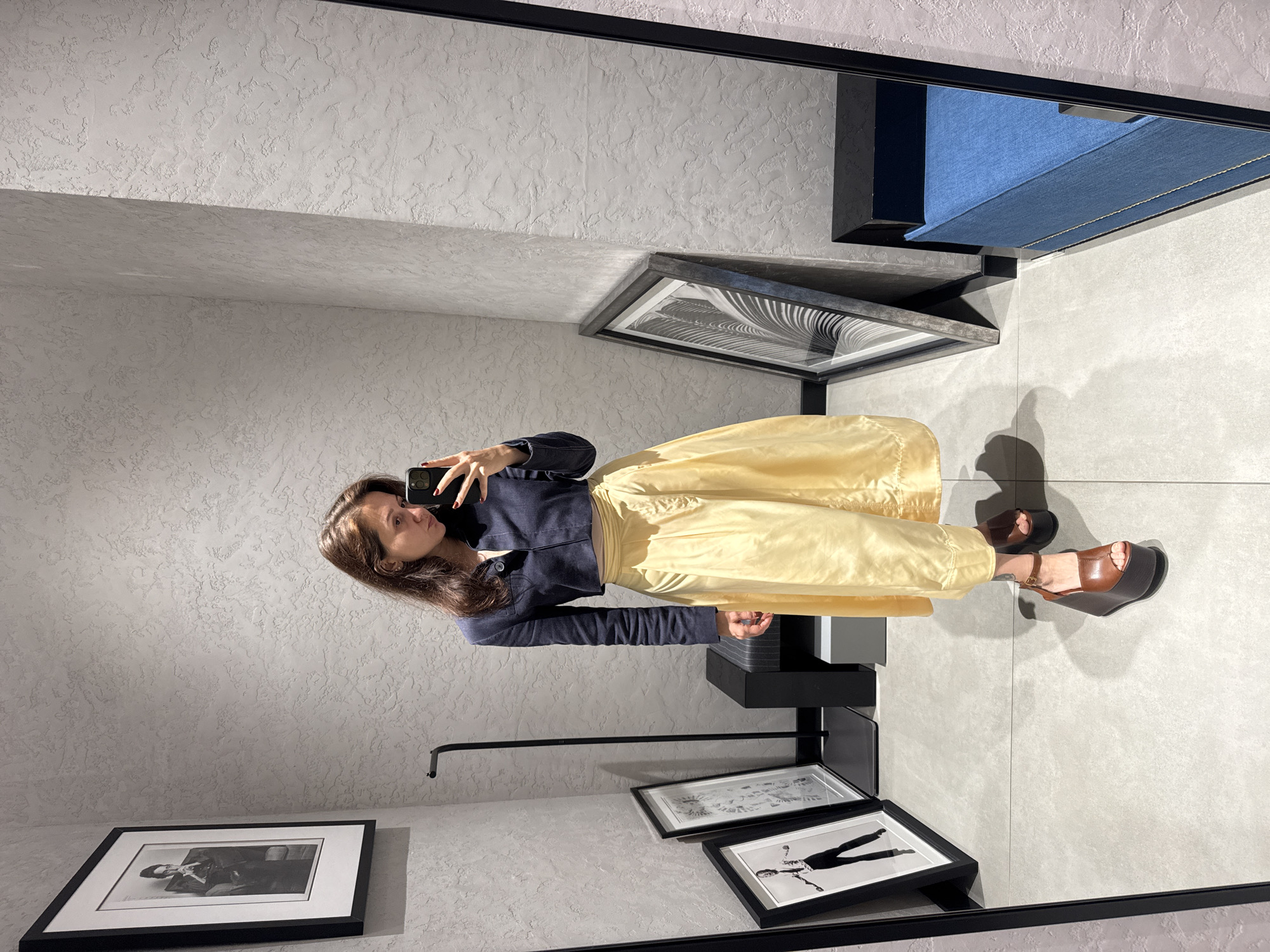 Woman photographs herself in Dubai clothing store early morning