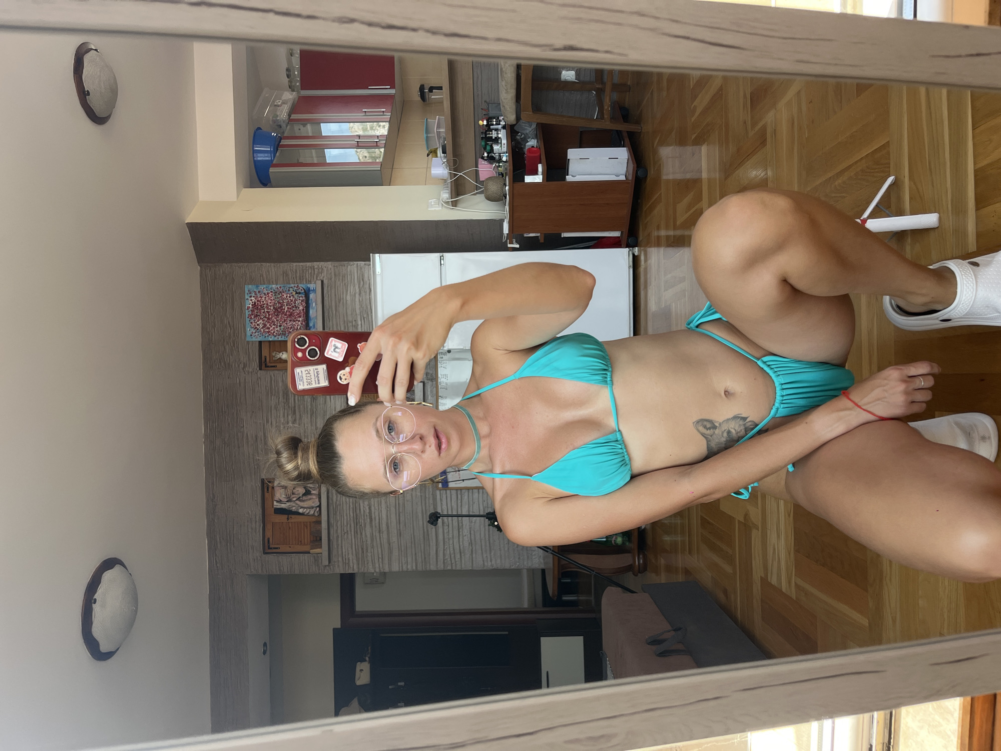 Mirror selfie in turquoise bikini and white Crocs