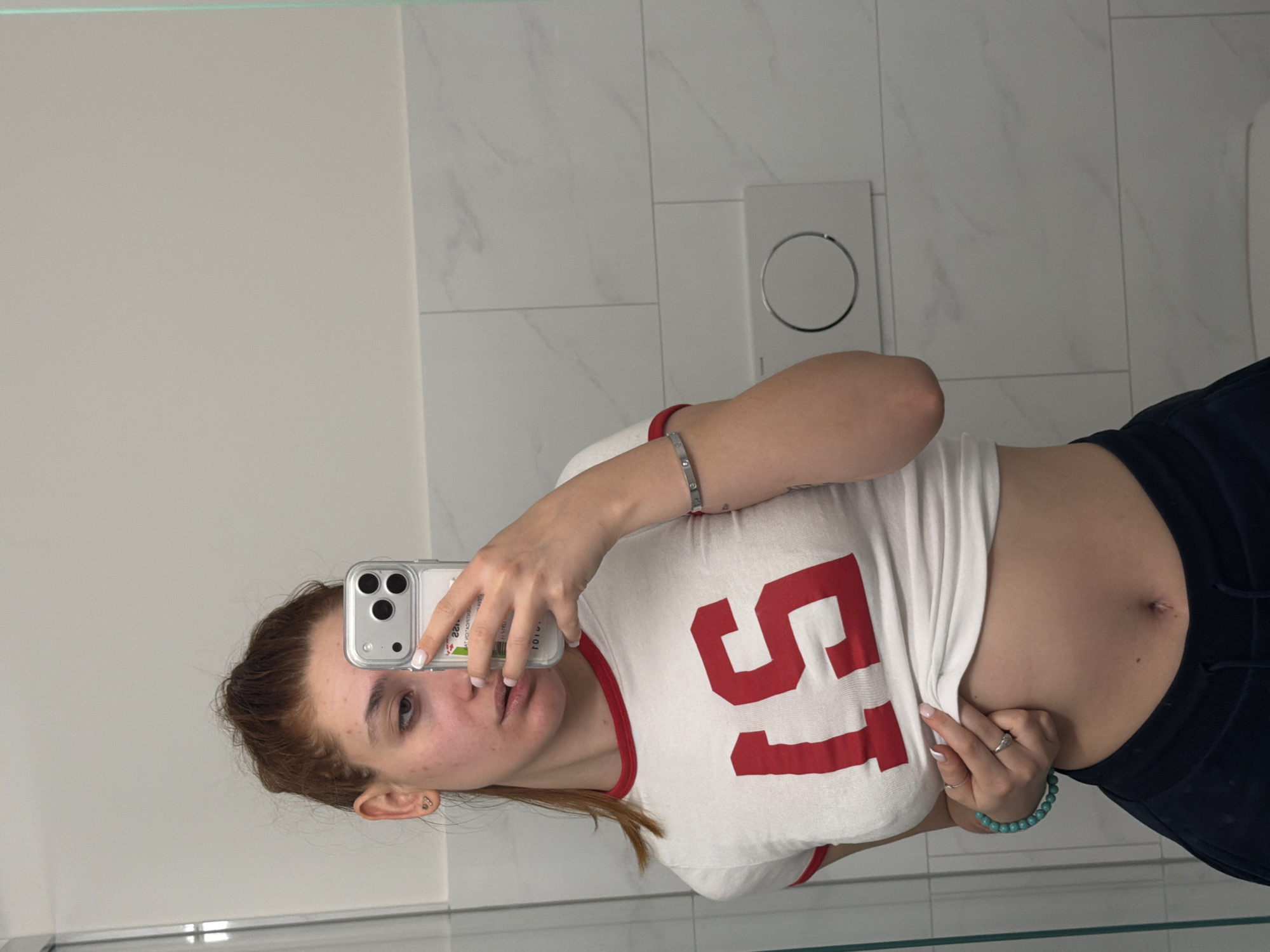 Woman takes bathroom mirror selfies in Bremgarten, Switzerland