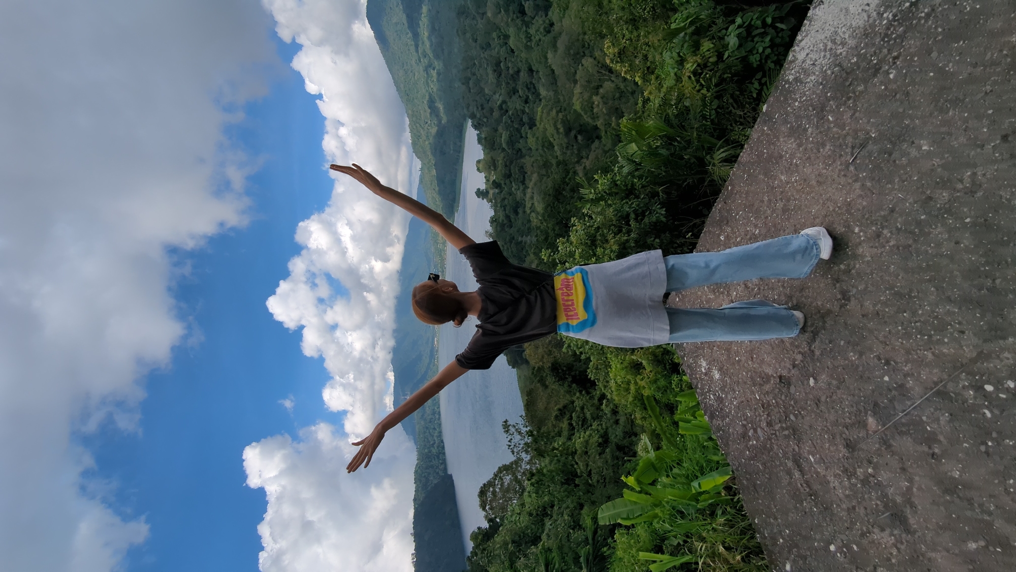 Woman enjoys scenic mountain lake view in Banjar, Indonesia