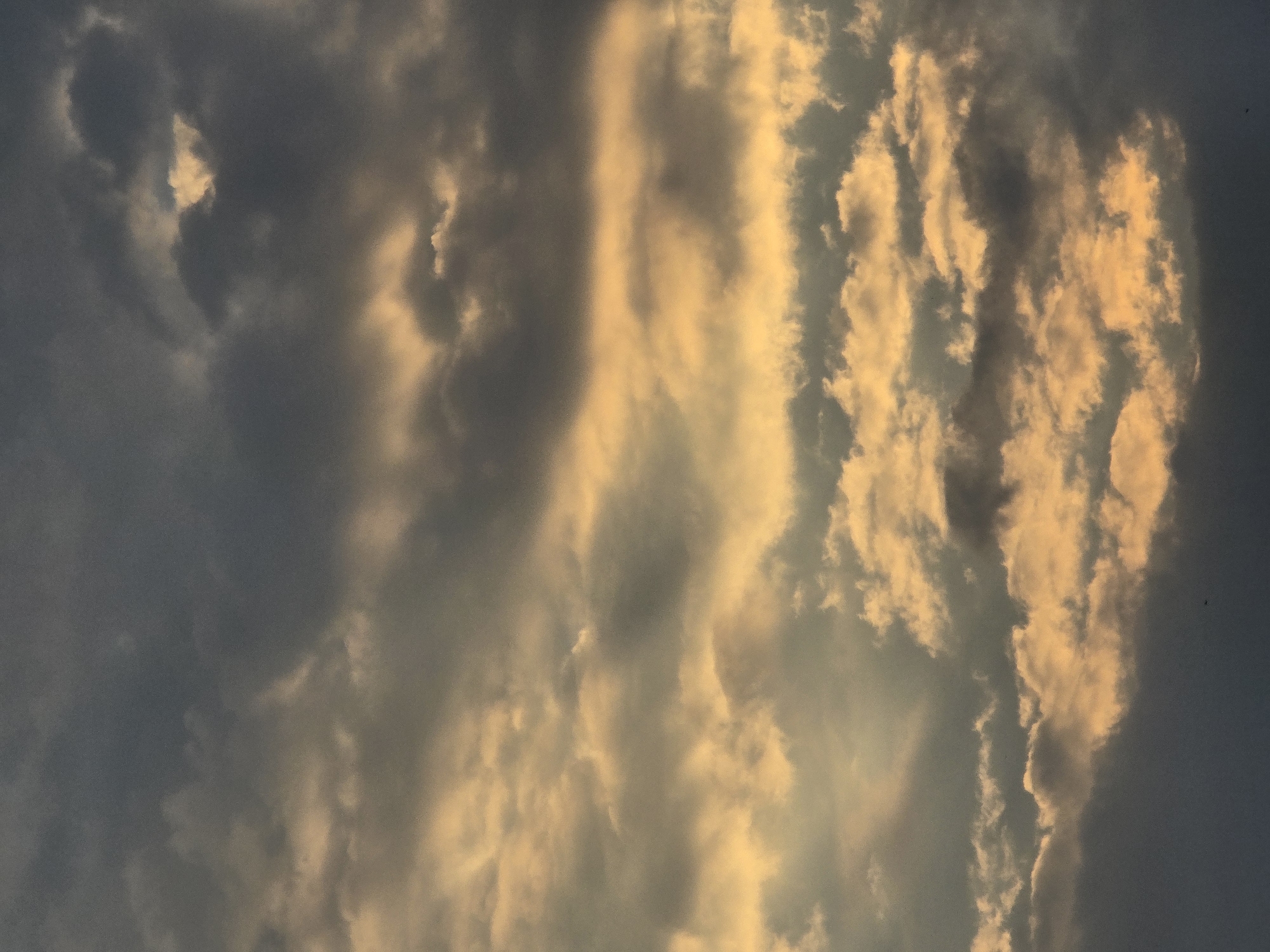 Dramatic cloud formations roll over Vilnius at golden hour.